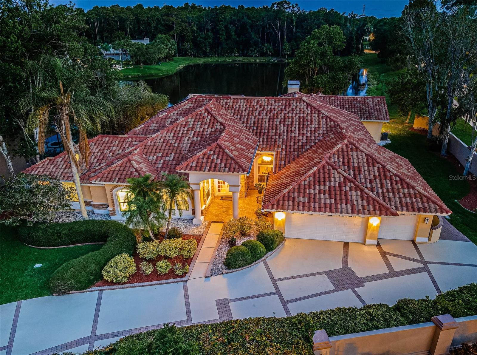 An Amazing Ensemble of Stunning Views, Serene Privacy and the Ultimate Grandeur of a Primary Suite en par with those of Luxury Hotels – this home is nestled in the desirable Aberdeen subdivision in the Gated, Golf Community of East Lake Woodlands and features 4 Bedrooms + Office/Den, 3.5 Baths, Open Floor Plan and flexibility. With No Neighbors on 3 Sides, a Privacy Wall and Lush Landscaping, this home provides that Much Sought-After Feel of Seclusion. A true treasure is the Expanded, Custom Primary Bath designed with Beautiful Marble accenting the Flooring and Showers - and yes there are 2 Full-Sized Showers with the Second serving as a Steam Shower to totally immerse yourself in the feeling of a Spa Experience every day! Chandeliers and Gorgeous Granite complement the design adorning the Large Jetted Tub and Expansive Double Vanities complete with Heaters at the Base of the Cabinets to blow Warm Air when it gets chilly. The Sheer Size of this Extraordinary Bath adds to its Luxury and provides a Comfortable and Tranquil Lounging Area with Custom Closets within close reach. As for peace of mind, Hurricane Impact Windows were installed in 2020 replacing all Windows with the exception of glass sliders/transoms. This Lot is located in the preferred Flood Zone X which does not require flood insurance and the owners had no issues during the 2024 hurricanes. Another Special Feature is the 4th Bedroom spanning 28 feet to accommodate Extra Living Space for family or guests or serve as a Bonus or Sports Room, Additional Office, Playroom, Home Gym or Multi-Purpose Space – perfect to meet your individual needs. (Pool Table and some home furnishings are negotiable). A Pavered Drive and Walkway set the tone leading to this home’s Double Entry Doors and Gracious Foyer. Accented with Volume Ceilings, Rich Crown Molding, Hardwood Flooring and Plantation Shutters, Open Gathering Space abounds with Glass Sliders and Transom Windows streaming light and surrounding the Pool and Lanai creating the ambiance of a Private Resort. There’s Plenty of Room for Several Cooks and Entertaining in this Open Kitchen flowing seamlessly with the Family Room highlighted with a Fireplace as the perfect focal point. Stainless Steel Appliances including Double Convection Ovens, Wine Fridge, Full Size, Glass Door Bar Pantry and loads of Gleaming Granite Counter Space and Breakfast Bar make this Kitchen highly functional and appealing. The Secondary Bedrooms are Oversized at 12’ x 14’ and the respective Bathrooms exude Soft Neutral Tones and Stunning Tile. Step outside to the Sparkling Heated Pool and Spa complete with Travertine Lanai and that Relaxing Water View. Updates include Tile Roof replaced in 2017, Travertine Pavers added and Pool Resurfaced with Pebble Sheen Finish in 2020, Stainless Steel GE Profile Dishwasher in 2021, GE Island Cooktop in 2023, Kitchen Fridge New in 2021 and Full-Size Fridge for Outdoor Kitchen New in 2024. Separate A/C units for main area (2018) and primary suite and bonus room (each 2017). Enjoy a wide array of Amenities with Ardea Country Club optional memberships featuring 2 Golf Courses, Tennis and Pickle Ball, Fitness Center, Lap and Freeform Pools, Dining and Social Events. All this in a Premier Location Convenient to Tampa International Airport, Medical Facilities, A-rated Schools, Award-Winning Beaches as well as Professional Sporting Events, Concerts, Fine Dining and more in the Tampa Bay Area.