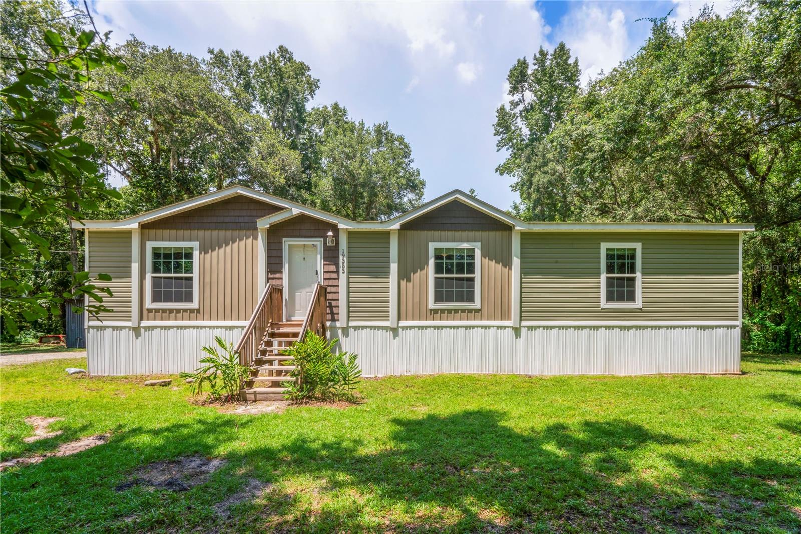 Charming 2017 Manufactured Home on Nearly an Acre – Private Corner Lot just off Ponce De Leon 98, & Cobb Rd.
Bring your family, pets, and big dreams—this property offers plenty of room to roam, play, relax, and create. Enjoy easy access to nearby amenities while savoring the tranquility of this private retreat.
Discover peace, privacy, and functionality in this well-kept 3-bedroom, 2-bath manufactured home nestled on a spacious corner lot—almost a full acre—with direct access to Highway 98. Located just minutes from downtown Brooksville and under an hour to Tampa, convenience meets serenity in this ideal Florida setting.
Home Highlights:
-Open-concept split floor plan offering maximum comfort and privacy
-Gorgeous natural light through beautiful windows and built-in shelving
-Large island kitchen with generous counter space—perfect for family meals and entertaining
-Inside laundry room for added convenience
-Two full baths featuring separate showers and tubs
-New carpeting plus tile flooring throughout
-Spacious walk-in closets in all three bedrooms
-Separate workshop with electricity—ideal for hobbies, projects, or storage
-Covered parking for vehicles or outdoor gatherings
-Man-made pond in the backyard—bring your fishing pole!
-Fire pit setup for cozy nights outdoors
-Partially fenced with no through-traffic for extra safety and quiet
-No HOA and no restrictions—your land, your lifestyle!