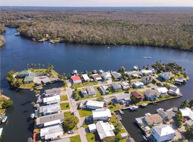 HOMOSASSA WATERFRONT !!! Direct River View From This Amazing Canal Front Block Home. NO FLOOD DAMAGE !!! HUGE 80 FOOT SEAWALL FOR LARGE BOATS !!! Currently Being Used as a Vacation Rental This 4 bedroom, 2 and a Half Bathroom Home Can Be Used as a Short Term, Long Term, or Full Time Residence. This Property Comes Turn Key and Fully Furnished W/ Coastal Themed Decor. Kitchen W/ Hickory Cabinets, Breakfast Bar and Stainless Appliances. Living Room W/ 65 Inch Smart TV. Dining Room W/ 3 Sets of Glass Sliders That Provide Great River Views. King Bedroom W/ 55 Inch Smart TV, 2 Queen Water View Bedrooms W/ 55 Inch Smart TV's, "Bunk Room" Bedroom W/ 4 Twin Beds and a Built in Desk Area W/ 65 Inch Smart TV. Laundry Room W/ Pantry and Utility Sink. Screened in Patio/Game Area W/ 65 Inch Smart TV. The Outside Storage Building Has Room For Your Kayaks and Paddle Boards. Golf Cart Sized Attached Garage is Currently Being Used For Storage and Supplies. The Huge Yard is Fully Fenced W/ Extra Space For Parking, Boats and Trailers. Located Walking Distance to Seagrass Resort and Margarita Grill, Minutes to the Famous Monkey Island, Mcraes, The Old Mill, Crumps and Other Popular Homosassa Fun Spots.