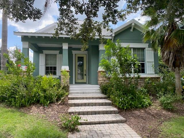 “Beautiful Cottage designed 3 bed/2 bath home”. Expanded front open porch with ceiling fan. Separate kitchen with “open bar” to Great Room to include dining area and large living room. Kitchen is complete with dishwasher/microwave/range/refrigerator/custom wood cabinets/gorgeous granite countertops. Unique designs: one elegant bathroom services two bedrooms. Second private bath is connected to the large rear bedroom that features a French Door opening to a stunning glass porch located within a beautiful landscaped patio and flower garden. Additional amenities include: rear attached garage with guest parking in front parking area; use of large custom community pool with separate dressing room and bath; Lake Eustis access by a community dock; basketball court & tennis court; lawn care, irrigation system, mowing and landscape maintenance.