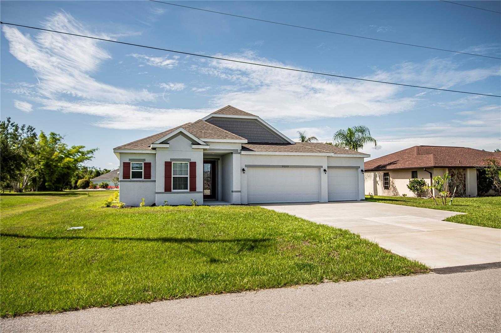 Don't wait years, face roadblocks or unexpected price hikes to start and complete a new build. Here is your golden opportunity for a 2023 Maronda Drexel 3 car garage, 3 bedroom, 2 bath on a private cul-de-sac in deed restricted Deep Creek! Privacy plus with the double green space back yard with room for a pool and impressive upgrades offers a luxurious and contemporary living experience. Upon entering the luxurious leaded glass front doors, you'll step into an elegant foyer that sets the tone for the rest of the residence. The spacious and welcoming interior boasts an open floor plan with grand 9'4" ceilings and an abundance of natural light. The main living area is large and thoughtfully designed to be both stylish and functional. Tile throughout the home adds elegance and durability. The kitchen is a chef's dream, equipped with top-of-the-line stainless steel appliances, ample cabinet space with soft close drawers and cabinets, and level 2 quartz countertops. The sleek design and modern fixtures give the kitchen a contemporary feel, while a large island provides additional workspace and a breakfast bar for casual dining.The master suite is a true retreat, offering a generous amount of space and privacy facing the extra green space. It features a luxurious en-suite bathroom with dual vanities, a rich soaking tub, separate shower, beautiful quartz countertops and a walk-in closet. The additional bedrooms are also well-appointed and provide comfort and convenience for family members or guests. An inside laundry room, dimensional shingles, top Moen fixtures, hurricane shutters, and a smart home hub, lights and locks along with Maronda's Bee Smart energy program that exceeds Energy Star strict guidelines to save you money on utility bills. Not in a flood zone so enjoy savings with lower insurance premiums. 10 year warranty the foundation and structure will be transferred to the new owner. This Southwest Florida location is ideal for year-round enjoyment of boating, fishing, golfing, Several Gulf beaches, beautiful natural resources, many restaurants, parks, public tennis courts and shopping. Cultural events are held throughout the year, multiple baseball parks are also located close by. Home is located just 29 minutes from Tampa Bay Rays Training Stadium, 11 miles from shopping mall & many Parks, 47 minutes from multiple Gulf Beaches, Punta Gorda regional Airport is located 10.7 miles away which is serviced by Allegiant air. Fisherman's Village and Historic District are about 10.6 miles away with multiple restaurants and shopping.This exceptional property truly embodies comfort, elegance, and an enviable Florida lifestyle. Hurry to see this never been lived in home that's ready for you today!