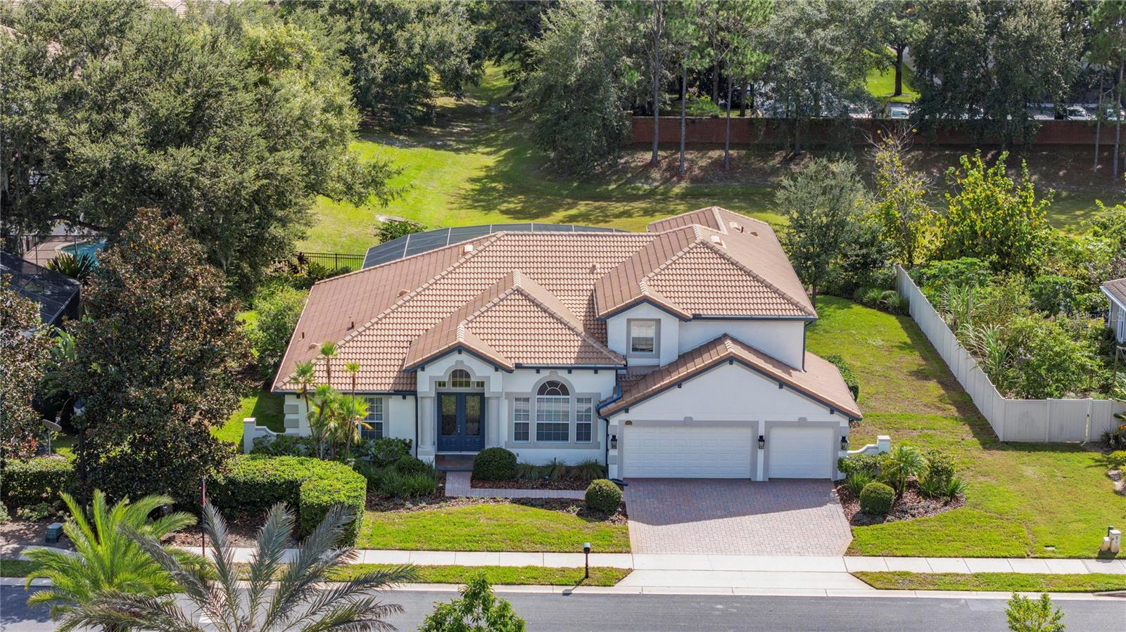 Experience the essence of refined Florida living in Wilson Park, an intimate gated enclave of just 29 distinguished residences. Positioned on one of the community’s desired lots, 5723 Bassett Place enjoys sweeping views and unrivaled privacy with no rear neighbors and the deepest backyard in the neighborhood. Spanning nearly 3,900 square feet, this elegant residence captures the sophistication of modern design and the comfort of a timeless retreat. Grand ceilings, open living spaces, and newly refreshed designer flooring invite a sense of airiness and flow throughout. From the moment you enter, natural light pours through expansive sliding glass doors, framing a breathtaking view of the sparkling pool and sun-splashed lanai beyond. The thoughtfully designed floor plan includes a private office, a formal dining room for memorable gatherings, and a spacious family room that effortlessly connects to the kitchen, creating an environment for entertaining and everyday living. The chef’s kitchen offers a large center island, breakfast bar and a sun-filled nook wrapped in mitered glass for serene pool views. The primary suite serves as a luxurious sanctuary with dual walk-in closets, private access to the lanai, and a completely reimagined spa-inspired bath showcasing large-format tile flooring, a soaking tub, a frameless glass shower and dual vanities. Two additional bedrooms and a spacious laundry room complete the first level, while the second floor opens to a generous loft, plus a bonus room and an additional bedroom and bath. Outdoors, a spectacular pool and spa take center stage within the screened lanai, an entertainer’s paradise and the ultimate escape for relaxation under the Florida sun. The oversized three-car garage and expansive yard add the finishing touch to this extraordinary offering. The new owners will love these additional improvements, including HVACs, tankless hot water, pool pump, pool heater, and water softener and filtration system, all in the last few years. Life at Wilson Park offers a balance of privacy, prestige and convenience, where every day feels like a resort getaway, while only minutes from the best of Sanford and Lake Mary, including acclaimed medical centers, boutique shopping, top-rated golf and country clubs, with effortless access to Orlando, Winter Park, and Central Florida’s renowned attractions and beaches.