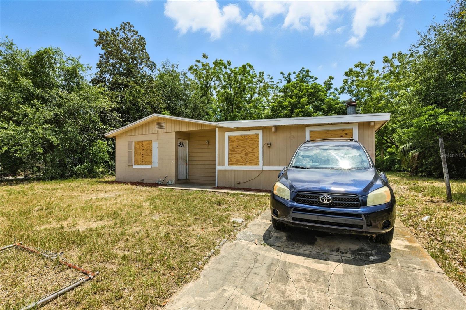 Tucked away on a spacious corner lot in Orlando and surrounded by mature trees, this block home offers incredible potential in one of Central Florida’s most convenient locations. Just a short drive from downtown, theme parks, and major highways, it provides easy access to everything that makes Orlando such a desirable place to live. Inside, you’ll find tile flooring throughout the main living areas and a standout brick fireplace that adds charm and character. Step out to the screened-in back porch, perfect for relaxing or entertaining while enjoying the privacy of the backyard. With plenty of room to grow and a location that puts you close to it all, this property is full of opportunity.