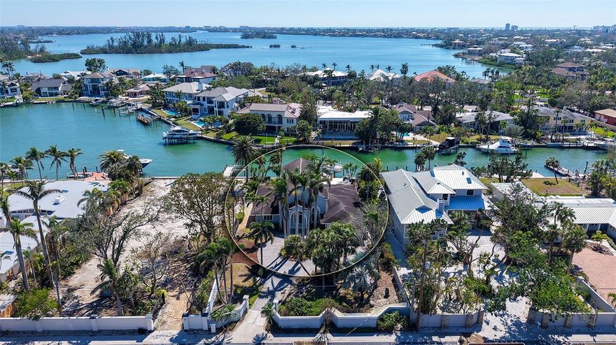 Extraordinary waterfront property with expansive Intracoastal Waterway views located on the sought after north end of Siesta Key. Now is the perfect opportunity to build your dream waterfront estate on this exceptional almost one-half acre lot in Bay Island Shores community. This beautiful lot that exudes the exquisite panoramic views of Sarasota Bay and Intracoastal with protected sailboat water.  It features a 90 foot canal front with 73 feet of composite and tile dock. The seller will pay for the house to be razed and the lot to be scraped. The fabulous location affords you the opportunity and convenience of easy access off Siesta Key and very close to the Number One Beach in the country according to Trip Advisor with its azure blue shimmering waters. This is Siesta Key Paradise at its very Best!!!