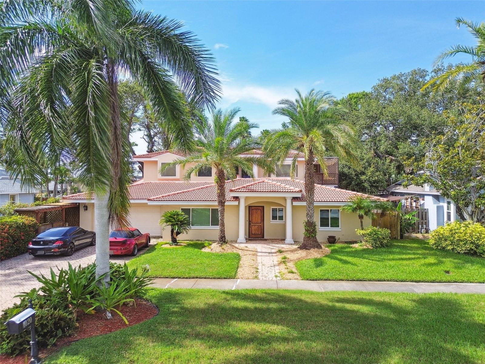 Welcome to your private compound in a prime Clearwater/Dunedin location just one block from the Gulf of Mexico with peek-a-boo water views from the top deck. This sprawling 6-bedroom, 6-bath estate is a rare gem designed for luxurious living and effortless entertaining.
The main home offers four spacious bedrooms and four baths. A custom solid mahogany front door opens to a light-filled interior featuring imported Italian porcelain tile, elegant crown molding, and tray ceilings. Triple sliding doors lead to a cozy fireplace room, seamlessly connecting indoor and outdoor living. The kitchen includes solid wood cabinetry, granite countertops, bar seating, and two large pantries, flowing easily into the formal dining room for dinners or game nights at the table. Enjoy movie nights or the big game in the bar room with theater seating. You will enjoy entertaining around the custom-built bar, crafted from antique brick dating back to the 1800s and topped with warm cypress wood, complete with a fridge, wet bar, and surround sound. Two en-suite bedrooms, an additional guest bedroom and guest bath finish out the main house first floor. The main house second floor is reserved exclusively for the primary suite. The primary suite is supremely spacious and private with high ceilings and a huge closet, you will enjoy the luxuries of space, storage and natural light with direct access to the upper deck, the perfect place to enjoy a peaceful evening drink while overlooking the Gulf under the stars.
Step outside to your personal resort. The saltwater fiberglass pool—refurbished just two years ago—is nine feet deep and set within a Texas Ripple Stone deck, with an upgraded biofilter system and an outdoor area ready to become your future outdoor kitchen. A lush grassy area for pets, private outdoor storage, and wrap-around cedar ceiling deck with spiral staircase complete the outdoor experience.
In addition to the main home, a detached two-story guest house adds incredible flexibility. It features one bedroom, one full bath, and a full kitchen—ideal for extended family, guests, or income potential with minimum one-month rentals allowed. A detached gym or studio adds even more versatility, featuring air conditioning, a full bathroom, on-demand water heater, and stackable washer and dryer.
Engineered for Gulf Coast living, the home is equipped with hurricane-rated windows, four in-ground electric subpanels, a French drain system in the backyard and storm-conscious upgrades to provide safety and security through every season. Enjoy peace of mind with a Carrier HVAC system with a coastal guarantee that’s just four years old, and a concrete tile roof, jet ski and kayak parking, and no HOA. A two-car garage offers additional storage and a laundry area, making this property as practical as it is luxurious.
Thoughtfully designed and meticulously maintained, this one-of-a-kind home delivers privacy, character, and unparalleled entertainment potential just steps from the Gulf and only 5 minutes from downtown Dunedin. Sunset walks along Edgewater Drive trail are just steps away or walk a block into the neighborhood to Charles Park. Dunedin is known for its walkable downtown, waterfront parks, local boutiques, breweries, and vibrant community events. Locals enjoy top-rated beaches like Honeymoon and Caladesi Islands, plus the scenic Pinellas Trail for biking and being active.
