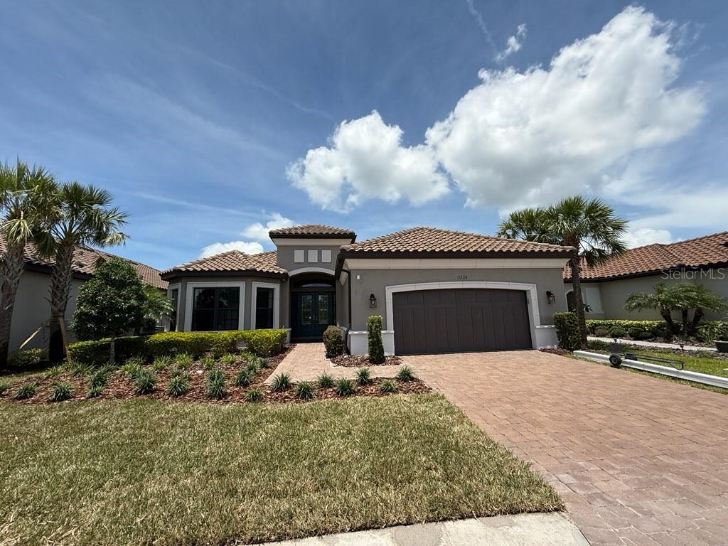 More than just a home, this property embodies a lifestyle! This stunning former model home features three bedrooms and three bathrooms, complete with a POOL. It offers everything you desire and more, showcasing exceptional designer upgrades and has never been lived in. The inviting, open floor plan facilitates seamless entertaining, both indoors and outdoors. The expansive great room boasts a tray ceiling, while the adjacent dining room is enhanced by mirrored accents that add a touch of elegance. The gourmet kitchen is a chef's dream, equipped with stainless steel appliances, built-in oven, gas cooktop, pantry, striking backsplash, and breakfast bar. The dinette area provides a casual dining experience. A versatile flex room serves as an ideal office or den, adaptable to suit your needs and offering the extra space you desire. The spacious primary suite, located at the rear of the home, is a refined retreat featuring a sitting area, bay window, an oversized walk-in closet, and an ensuite bathroom with dual vanities, a makeup area, and a large walk-in frameless shower. Guests will feel pampered in the two guest bedrooms; one includes a private full bath with a shower, while the other is conveniently close to an additional full bath. The laundry room is equipped with built-in cabinetry, countertops, and a sink. Are you ready to experience the backyard? The expansive lanai can be accessed through pocket sliding glass doors from both the kitchen and great room. This outdoor space features a covered lanai with an outdoor kitchen, flowing seamlessly into a sitting area with an outdoor fireplace. Cool off in the inviting pool or unwind in the spa while enjoying views through the panoramic screen enclosure. Esplanade at Artisan Lakes truly embodies resort-style living, offering a wealth of amenities which is located conveniently across the street. Enjoy a refreshing dip in the heated resort-style pool, engage in a game of tennis or pickleball, or take your dog to the pet park for a spirited game of fetch. You can also unwind with friends around the fire pit or attend community events organized by a full-time Lifestyle Manager. While relishing the exceptional array of resort-style amenities on-site, you'll also have easy access to nearby shopping, dining, medical care, outdoor recreation, beaches, nature reserves, and more. Don't miss out on this gorgeous home!