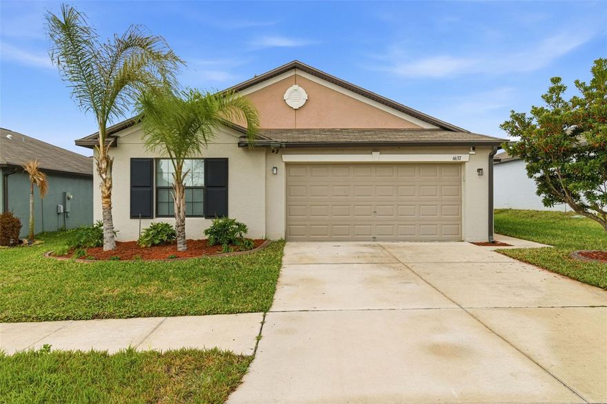 One or more photo(s) has been virtually staged. 6637 Wagon Trail Street, Zephyrhills, FL 33541 — Situated on a quiet cul-de-sac in the desirable Silverado Ranch community, this beautifully maintained Harrisburg model by Lennar offers 4 bedrooms, 2 bathrooms, 1,817 square feet of living space, a 2-car garage, and owned solar panels (2025) designed to help maximize energy efficiency. As you approach the residence, Florida-friendly landscaping, fresh mulch beds, and a six-zone irrigation system create a polished first impression. The driveway leads to a covered entryway accented with solar-powered lighting, setting the tone for the thoughtful details found throughout the home. Step inside to a welcoming foyer filled with natural light and enhanced by an updated lighting fixture. The foyer opens seamlessly into the dining room, where another updated fixture creates an inviting setting for gatherings and everyday meals. Designed with an open-concept layout, the dining area flows effortlessly into the heart of the home, the kitchen. The kitchen is both stylish and functional, featuring recessed lighting, solid wood cabinetry, porcelain tile flooring, stainless steel appliances, and a large center island perfect for meal preparation or casual seating. An eat-in kitchen space provides additional room for everyday dining and entertaining. Just off the kitchen is a conveniently located laundry room equipped with a 2024 washer and dryer and upper shelving for added storage and organization. Adjacent to the laundry room are three spacious secondary bedrooms, each offering expansive closets and flexible space for family, guests, or a home office. A full bathroom serves this wing of the home and includes an updated lighting fixture. On the opposite side of the residence, the living room provides a comfortable space for relaxation and entertaining. Sliding glass doors fill the room with natural light and provide direct access to the outdoor living area. Tucked just off the living room is the expansive primary suite, designed as a private retreat with views of the backyard. The suite features a large walk-in closet complete with a custom closet system and a built-in Liberty Safe. Rated for 1200 degrees for 60 minutes, EMP-resistant elec. lock, weighs 690 lbs empty, and measures 60.5"x42"x27.5".  The primary ensuite bath offers recessed lighting, updated fixtures, a dual-sink solid wood vanity, and a glass walk-in shower. Outdoor living continues on the covered and screened rear patio, creating the perfect space to enjoy Florida’s year-round sunshine. The fully fenced backyard with durable PVC fencing offers plenty of room for outdoor activities, gardening, pets, or future enhancements. Notable features and updates include: Roof (2018), HVAC (4 ton) (2024) with updated ductwork and infrared lighting installed, Water Heater (2018), Refrigerator (2024), Range (2024), Dishwasher (2024), Disposal (2018), Microwave (2018), Updated ceiling fans, Vivint Security System, app-controlled garage door system, and owned solar panels (2025). Residents of Silverado Ranch enjoy low quarterly HOA fees of $223, which include basic internet and cable, along with access to community amenities such as a pool, playground, dog park, and scenic walking trails. Conveniently located with quick access to I-75, this home is just minutes from Downtown Zephyrhills and Downtown Dade City, multiple fitness centers, and approximately 20 minutes from premier shopping and dining at The Shops at Wiregrass and Tampa Premium Outlets.