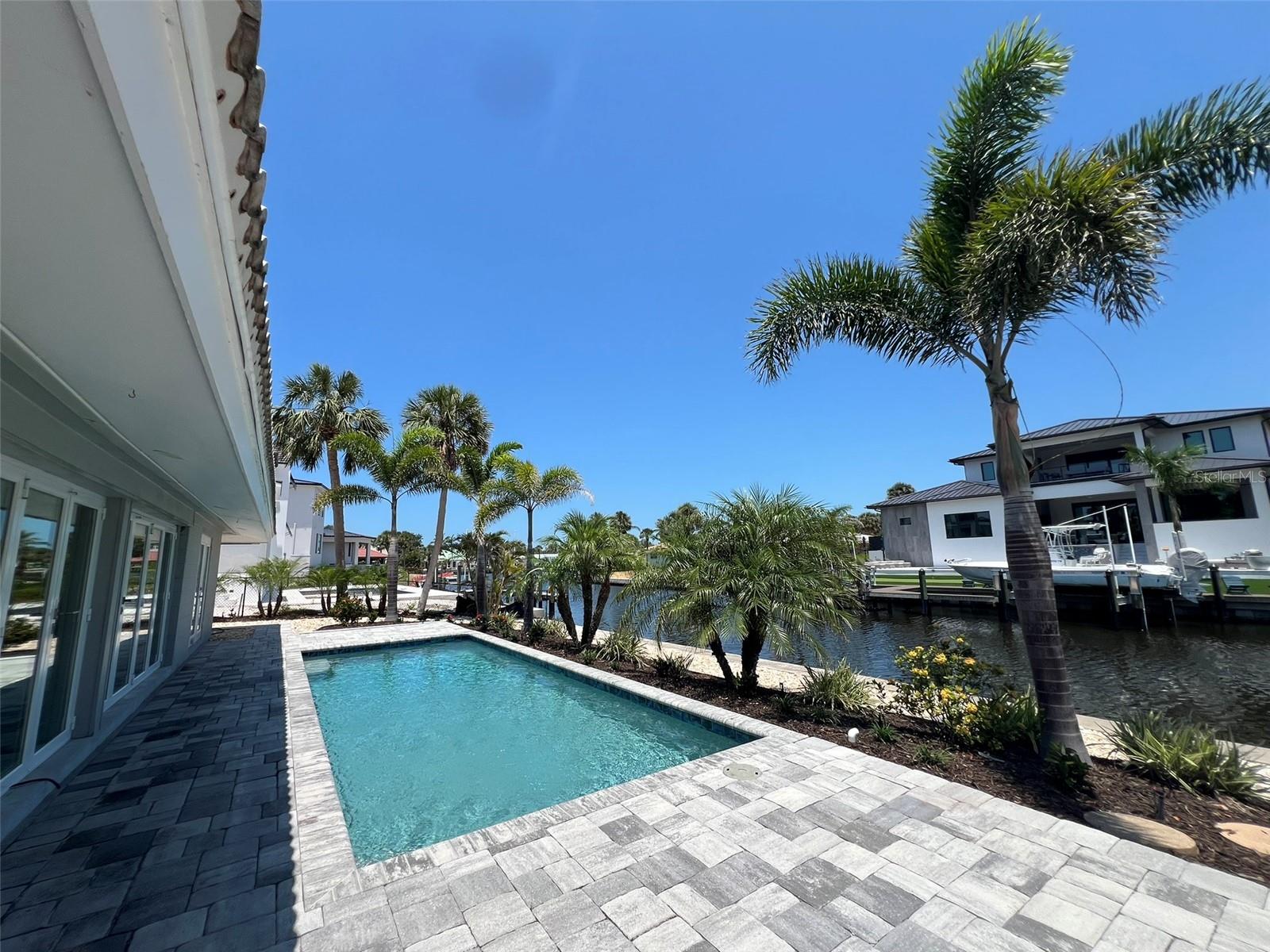 NEW PRICE! Rare waterfront Siesta Key pool home available for annual rental! This beautifully-renovated 3/2/2 pool home in Siesta Isles is available for immediate occupancy. This impressive property offers 100 feet of waterfront along Siesta Key's Grand Canal. The gourmet kitchen features quartz counters, stainless steel appliances, built-in microwave/wall-oven combo, island cooktop with hood vent, and large stainless steel sink. Walk-in showers in both baths; master offers double showers, guest bath offers a separate soaking tub. Stylish new luxury vinyl plank throughout is low-maintenance. Hurricane windows throughout offer thermal and impact benefit for your piece of mind. 2 outdoor showers on property. Heated saltwater pool with paver deck. This pet-friendly home is fully-fenced to the canal; 1 pet up to 35 lbs considered with application, app fee, and $25/mo pet rent. Per Google Maps, less than 1-mile walk on quiet streets to Siesta Beach. Lawn/yard care & pool maintenance included in rent. This is a no-smoking property. Unfurnished annual rental. Allow 2 weeks from application to occupancy.