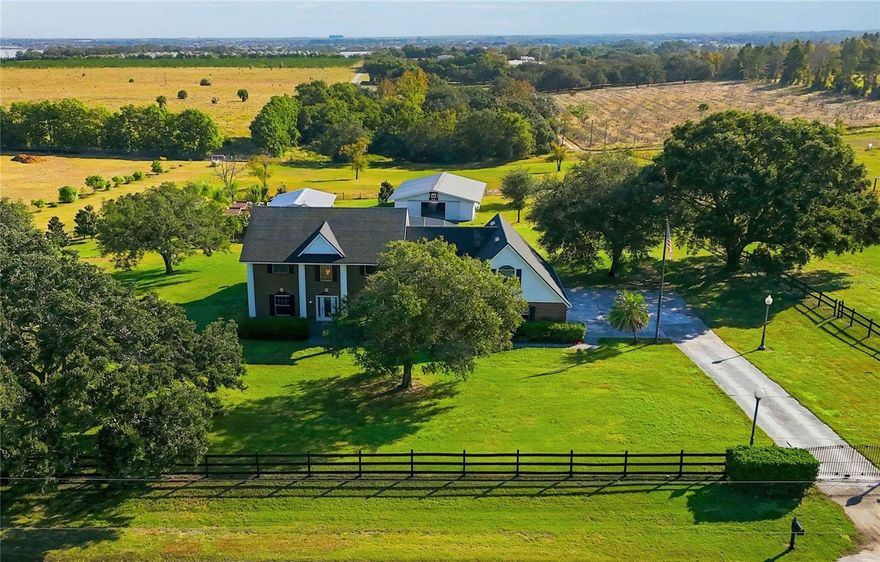 For a champion equestrian, home is more than four walls, it’s land that performs, space that protects your horses, and a setting that allows you to train, restore, and win.
Tucked away in a quiet corner of Winter Garden, yet located in Lake County for lower taxes, this rare brick estate delivers exactly that balance. Privacy when you need it. Convenience when you want it. Properties like this don’t come along often.
The heart of the estate is the oversized barn, designed with intention and function: aluminum siding, a durable metal roof, six 12x12 stalls with running water, feeding stations, and a dedicated tack room that keeps everything organized and competition-ready. The fully fenced acreage is thoughtfully divided, giving your horses room to move while maintaining safety and control.
A separate utility building: currently serving as an aviary adds flexibility for training, storage, or future pursuits. Mature fruit trees enhance the landscape, reinforcing the feeling of a working yet beautiful agricultural retreat.
Inside, the home reflects the same balance of strength and refinement. The renovated kitchen is a showpiece, featuring GE Café appliances, waterfall-edge granite countertops, and modern floating shelves, perfect for gathering after long days in the saddle. The expansive 17x21 family room, with soaring 19-foot ceilings, creates a dramatic yet inviting space, while the freshly updated dining room adds polish with new paint and trim.
Upstairs, a versatile loft can easily become a fifth bedroom, and the oversized bonus room (13x31) offers endless possibilities: gym, media room, or additional living space and complete with full-length storage. Each secondary bedroom includes its own private sink, connected by a Jack-and-Jill bath, with thoughtful reading lights for quiet moments of rest.
Finished with a newly installed epoxy garage floor, every detail of this home has been carefully considered.
This is where championship-level function meets everyday comfort. Just minutes from Winter Garden’s restaurants, shopping, and hospitals yet worlds away when you return home, this five-acre agricultural retreat offers the tranquility, space, and prestige of true country living.
Not just a home.  A lifestyle built for those who compete and expect more.