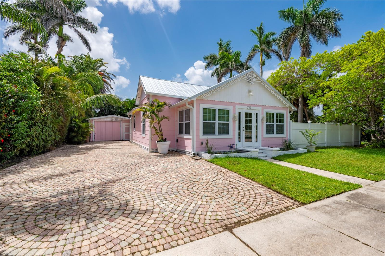 LOCATION IS EVERYTHING and this one delivers. In the heart of Punta Gorda’s historic district, this locally registered home blends classic character with modern comfort-just steps from Charlotte Harbor, the scenic Harbor Walk, Gilchrist Park’s pickleball and tennis courts, Fisherman’s Village, and a vibrant downtown full of restaurants, live music, and local markets. Behind its inviting facade with brick paver driveway, the home opens into a bright, open interior designed for everyday ease. A welcoming foyer leads into the spacious living and dining area, unified by new luxury vinyl flooring throughout. The kitchen features stainless steel appliances, abundant counter space, and direct access to the backyard-perfect for entertaining or relaxed coastal living. Off the living area, a private hallway leads to two well-sized bedrooms and two full bathrooms, including a beautifully updated main bath with dual sinks, a walk-in shower, and private access to the lanai. The newly added guest bathroom offers added privacy and convenience for visitors. Step outside, and everything slows down. Palm trees sway gently above a private pool, with space to lounge, grill, or drift off in a hammock. It’s a true backyard retreat designed for quiet enjoyment. The detached garage fits one car or provides bonus storage, and the fenced yard offers privacy with no HOA restrictions. Whether you're here for the season or something more permanent, this home’s unbeatable location and serene atmosphere offer something rare: small-town charm with everything you need just a short stroll away. Punta Gorda Airport is only 10 minutes away, offering nonstop flights from over 55 cities. Sarasota and Fort Myers airports are nearby as well-making visits from friends and family a breeze. This property is an excellent investment opportunity or simply a peaceful place to call home in one of Florida’s most charming towns.