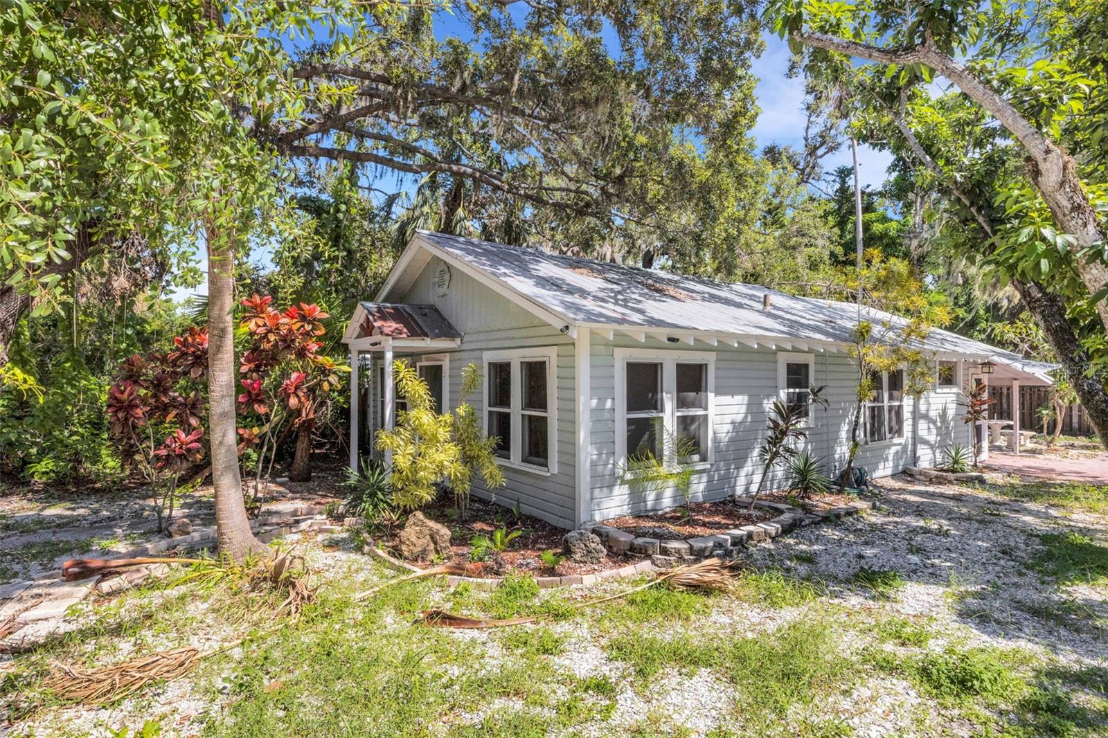 Come see this cute, rarely available, 2/1 cottage just minutes away from Downtown Sarasota, Ringling campus, Lido Beaches and St. Armand's. Plenty of parking for your toys with a two-car tandem carport, this home also touts beautiful mature landscaping throughout. Just needs your finishing touches to make it your own. Also, could make the perfect rental with so many amenities nearby. Come see today!