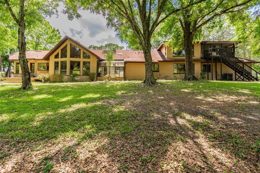 Set within 34± acres of protected Florida ranchland, this extraordinary two-home property offers a rare lifestyle designed for aviators, ranchers, farmers, and nature enthusiasts seeking privacy, open skies, and the freedom to live close to the land. Surrounded by working cattle ranches, crop farms, and wide-open countryside, the property benefits from a Florida land conservation protection that prevents future development, preserving the peaceful rural landscape and ensuring lasting privacy, natural beauty, and unobstructed views for generations to come.
At the heart of the ranch is a 3BR/3BA, 3,728 SF rustic lodge-style main residence overlooking a serene pond and rolling pastures. The home features soaring cathedral ceilings, a cozy wood-burning fireplace, and expansive windows that bring the beauty of the outdoors inside. For aviation enthusiasts, the property includes its own private airport — BURNTWOOD RANCH (FL43) — with a 2,600' x 150' engineered grass runway, private hangar, and enclosed observation deck, creating the perfect setting for pilots who value the convenience of flying directly home.
The ranch also offers excellent infrastructure for agricultural or equestrian use, including a pole barn with electric and water, open acreage for horses, cattle, or crops, and endless space to expand your vision of ranch living. A separate 2BR/1BA, 1,600 SF renovated guest residence with new roof and A/C provides flexibility for guests, caretakers, tenants, or multi-generational living.
Recent improvements include new interior paint, a new pool cage, and custom gated ranch entrance, enhancing both privacy and arrival experience. Free from HOA restrictions or aviation community limitations, this property offers true independence while remaining conveniently located within reach of major highways, dining, shopping, and the international airports of Orlando and Tampa.
Whether you’re landing your plane at sunset, tending livestock at sunrise, or simply enjoying the quiet beauty of preserved Florida ranchland, this one-of-a-kind estate offers an authentic ranch lifestyle where nature, aviation, and privacy come together in perfect harmony.