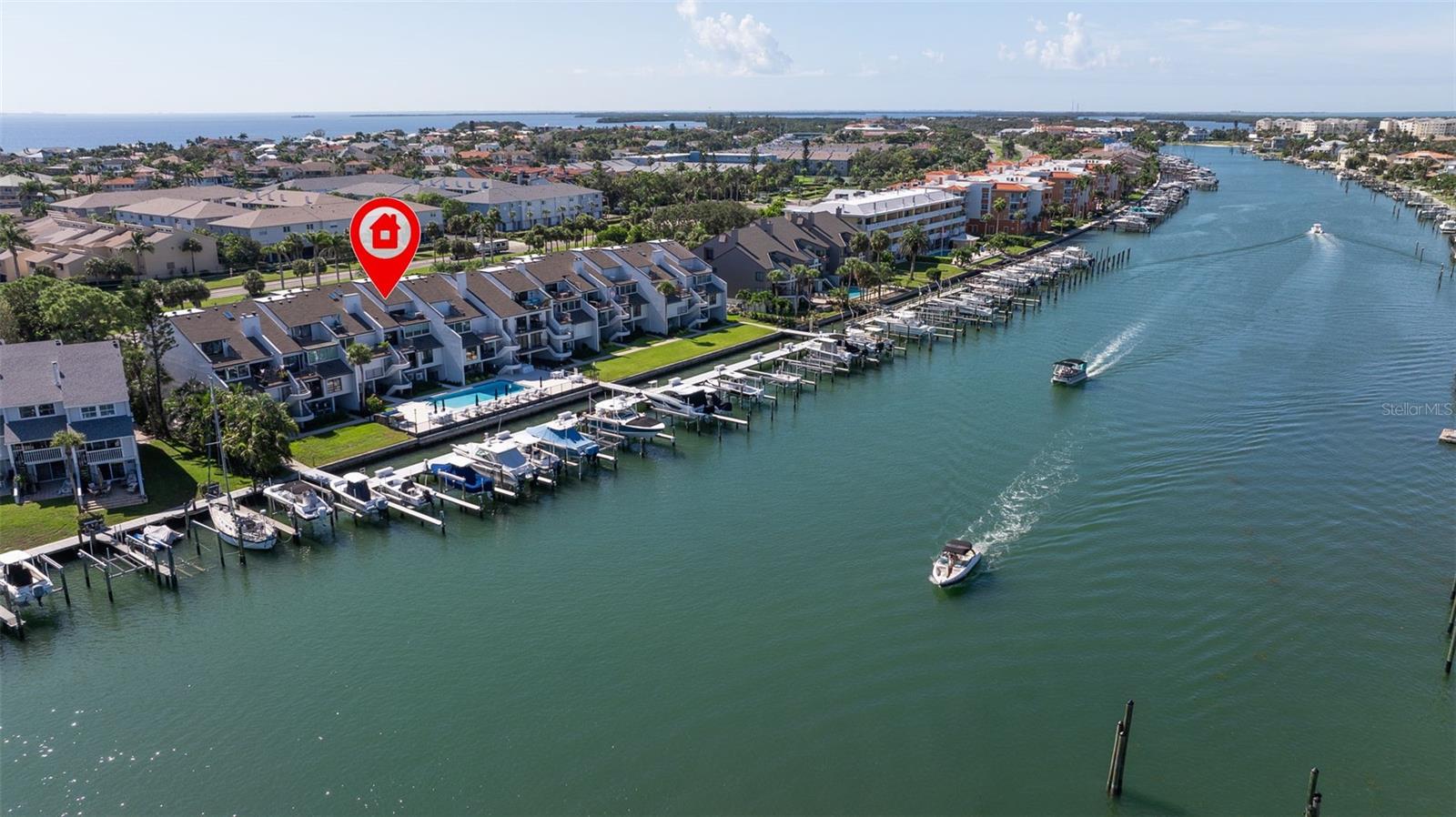 Coming home every evening to magical sunsets over Tierra Verde’s Grand Canal — this is the waterfront lifestyle you’ve been dreaming about. Spacious, open, and thoughtfully designed, this 2-bedroom, 2-bath condo offers effortless coastal living in a vibrant, welcoming community. The friendly entry with inviting porch greets you even before you step inside, showcasing the warmth of island life.
As you enter, the elegant coastal-inspired kitchen on your right features soft blue cabinetry, quartz counters, and a breakfast bar with seating for casual dining. On the left, the dining area includes a custom built-in wood bar and beverage fridge — perfect for serving to the dining table next to and entertaining guests. The tiled living area flows naturally with space for your sofa and TV while overlooking the balcony and sparkling Grand Canal, with a private back door entry staircase down to the heated pool for added convenience.
The primary suite is a true resort-style retreat with sweeping water views, custom lighting, an oversized walk-in closet, two separate vanities, and a fabulous spa-like walk-in shower. The guest bedroom, enjoys ample daylight, a spacious walk-in closet, and an updated bath. Full-size side-by-side washer and dryer plus additional large storage room downstairs with new water softener to complete the unit. Easy to maintain and lock-and-leave, it’s perfect for full-time living or as a second home.
2 assigned parking spots plus available guest parking spots in this waterfront, pet friendly, freshly painted and landscaped community. Featured amenities include a recently updated pool and fitness center. Enjoy waking or biking: designated bike and walk trail along Pinellas Bayway or downtown Tierra Verde, which offers several island restaurants. Scenic walk or ride across the bridge brings you to Isla del Sol Golf and Country Club. with close proximity to Fort De Soto Park and best local beaches, only 10 mins to Downtown St. Pete, and 40 mins to Tampa International Airport.
Complete your lifestyle package with the deeded boat slip and 13,000 lb lift. Furniture is optional, and the boat can be included— simply make an offer.