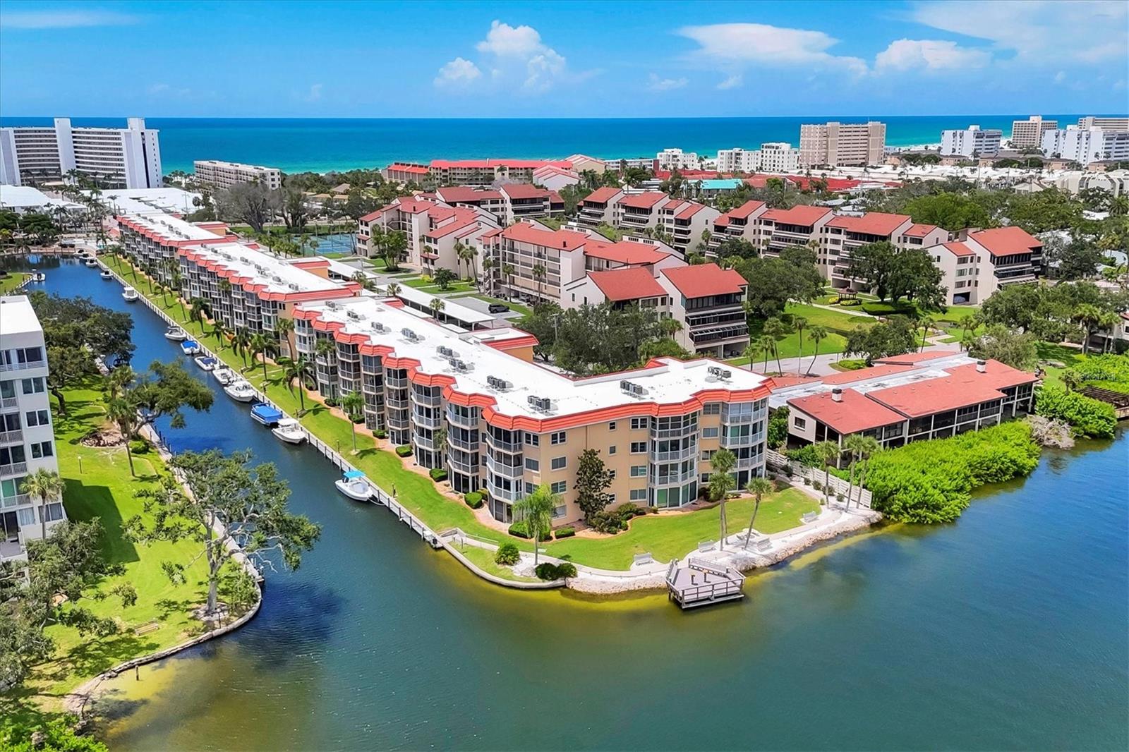 SIESTA HARBOR...55+...BEAUTIFUL CANAL & Intercoastal Water Way with incredible views of boats idling by and BEACH ACCESS. BRING YOUR BOAT up to 30' because it only costs $1,000 ANNUALLY to berth your boat! BUT WAIT till you see this TOTALLY RENOVATED BEAUTIFUL 1 bedroom 2 full bathroom condo! NEW, NEW, NEW...everything is new...Ceramic tile flooring, baseboards, interior doors & hardware, impact windows throughout, Popcorn removed and new texture ceilings, New electric plugs and switches, new kitchen with floating cabinetry, Quartz counters, new appliances, High end and modern lighting fixtures throughout, updated bathrooms also with floating vanities, incandescent lighting mirrors, new shower, New hot water tank, HVAC is only 2 years old, etc. You have plenty of storage as the bedroom has 2 closets (one is walk in), linen closet, Hall coat closet, pantry closet AND just outside your front door is a storage room for your bikes etc.! Amenities include a beautiful pool overlooking the water, shuffleboard, rec center, pier for boat watching and gatherings, tandem boat docks, fitness center FREE laundry on 2nd, 3rd and 4th floors PLUS FOB access to the beach across the street @ Crescent Arms. ALSO you have one DESIGNATED covered carport parking spot with plenty of guest parking #537. Outdoor grilling SPOT. Rental friendly but no pets except authentic guide dogs. PRICED BELOW MARKET AT $429,900