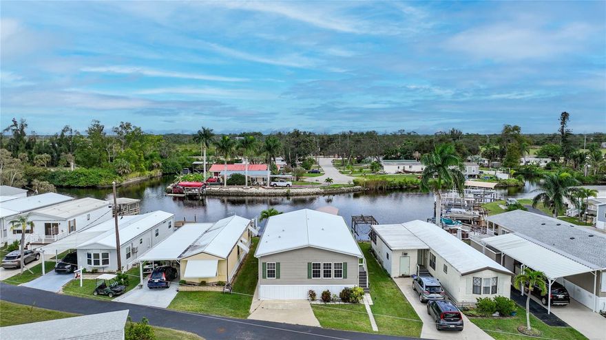 Welcome to waterfront living at its finest in Lazy Lagoon, a vibrant 55+ community! This elevated home boasts quick boating access and is a true gem for those seeking a serene and active lifestyle. As you approach, you'll ascend composite stairs to the inviting entry of this meticulously designed residence. Inside, discover a well-appointed floor plan featuring two bedrooms, a versatile den, a formal living area, a cozy family room, a charming dining room, and a practical galley kitchen. The master bedroom is a tranquil retreat, seamlessly connecting to the den and a private master bathroom. The spacious walk-in closet adds a touch of luxury, providing ample space for all your wardrobe needs. Step outside to your own waterfront oasis. A large porch awaits, perfectly positioned to capture stunning views of the water inlet. The dock beckons boating enthusiasts, complemented by a convenient boat lift and lift cover for hassle-free watercraft storage. Whether you're enjoying a quiet evening on the porch or setting sail for a leisurely boat ride, this waterfront home offers the perfect blend of comfort and recreation. Embrace the Lazy Lagoon maintenance free lifestyle – where every day feels like a vacation. Your dream waterfront retreat awaits!