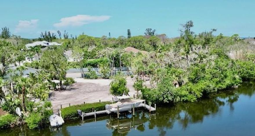 LIVE, BOAT, PARK while you build your waterfront dream home. Premiere waterfront lot opportunity in Sanderling Neighborhood. A rare chance to own one of the most sought-after lots in Sanderling. This private, fenced, waterfront retreat is located directly across from the neighborhood’s gated entrance, nestled in a serene basin leading to the Intracoastal Waterway. Extensive upgrades allow the future owner to enjoy the property immediately or stay on-site while building a custom beach home. Direct Waterfront Access ~150 ft of frontage along a private canal connected to the Intracoastal. Shared with only 5 neighboring Sanderling homes for enhanced privacy and exclusivity. New Garage & Apartment (2024) Two-story, block construction featuring a 1,100 sq ft 2BR/1Bath apartment with full kitchen above an oversized 3-car garage—perfect for storing vehicles, kayaks, golf carts, and more. Expansive Lot ±0.6 acre (25,553 sq ft) fenced lot with over 240 ft of frontage. Adjacent to HOA-owned land for added space, privacy, and mature vegetation—lives "like" a 1+ acre compound. Dock & Boat Lift Brand-new dock with a 10,000 lb. lift, ready for Gulf Coast boating and fishing. A 27 ft Scout boat (optional) currently sits on the lift and can be offered under a separate bill of sale. Build-Ready & Custom Plans Available. Lot is fully cleared and prepped for a custom-designed coastal contemporary home (3,300 sq ft, 3BR + Den, 4.5 Bath, pool, lanai, and more). Plans available for purchase or you can work with local Sarasota architects to tailor your dream design. Living in Sanderling means more than simply owning a piece of paradise. The neighborhood offers a suite of exclusive amenities designed for relaxation, recreation, and connection. Residents enjoy exclusive access to the Sanderling Beach Club and tennis & pickleball Courts: Whether you are an avid player or simply enjoy a casual match with friends, well-maintained courts are available for your enjoyment. This property stands alone in its exceptional array of features and amenities.