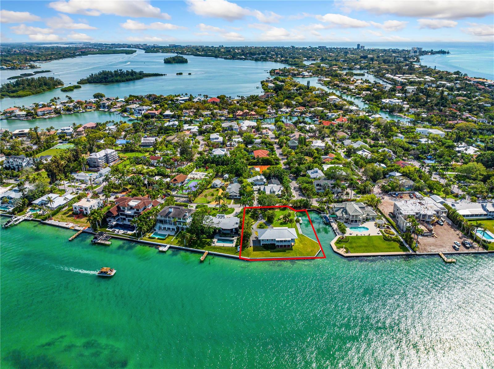 Welcome to one of the most desirable properties on Bay Island, “The Gateway to Siesta Key”. 609 Norsota Way is now on the market for the first time in over 42 years! The location of this exquisite piece of paradise offers one of the most impressive, unobstructive bay views of Downtown Sarasota, The Ringling Bridge, Bird Key, Lido Key, and the breathtaking sunsets Florida’s west coast in known for.
Nestled in the highly sought-after north end of Siesta Key, this residence boasts 4 bedrooms and 3 bathrooms, set on a remarkable 25,000+ square foot property. The awe-inspiring bay frontage spans an impressive 330' along two sides, featuring one of the only private boat basins on all of Sarasota Bay.
Unleash your artistic vision in this property that serves as a canvas for your creativity. You can choose to craft your own masterpiece home or restore the charming existing structure to its former glory. The property offers endless potential for entertainment and indulgence in resort-style living surrounded by the serenity and splendor of Sarasota Bay, while the private boat basin grants direct access to the pristine waters of the Gulf of Mexico.
Picture embarking on leisurely cruises or thrilling water sports adventures, creating enduring memories as you set sail from your private backyard. Poised above the tranquil bay waters, this property provides unparalleled panoramic views of enchanting sunsets, city lights, and the breathtaking beauty of nature. Seize this opportunity to own one of the most remarkable properties in Sarasota, where character converges with potential in an extraordinary setting. Your chance to own this distinctive waterfront haven awaits—call today for a private showing!