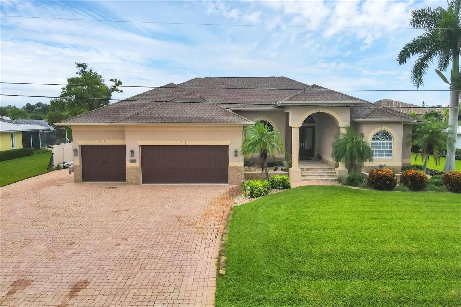 Welcome to your dream coastal retreat! This stunning waterfront home is perfectly situated on a saltwater canal with direct Gulf access and no bridges....a boater’s dream. Enjoy Florida living at its finest with luxurious indoor and outdoor features that truly set this property apart. A spacious paver driveway leads to this elegant residence, featuring a heated pool and spa, outdoor kitchen, and convenient pool bath....ideal for entertaining or relaxing year-round. The home is protected with impact windows and doors, hurricane shutters and a whole-house Generac generator, offering peace of mind during any season. Boating enthusiasts will love the composite dock equipped with two boat lifts (15,000 lb & 8,000 lb), running water, and a sink, making waterfront life effortless and enjoyable. Inside, you’ll find travertine flooring throughout, crown molding, high ceilings, and a thoughtfully designed open floor plan with split bedrooms for added privacy. A cozy wood-burning fireplace anchors the spacious family room, while a bonus room adds flexibility for an office, gym, game room or media space. The chef’s kitchen is equipped with KitchenAid appliances, induction cooktop, wall oven/microwave combo, large breakfast bar, and pantry....perfect for casual meals or gourmet cooking. The luxurious primary suite features two walk-in closets and a spacious en suite bath with a large walk-in shower, separate soaking tub, and elegant finishes....your own private spa retreat. Whether you're an avid boater, entertainer, or simply seeking the ultimate Florida lifestyle, this exceptional waterfront home has it all. Don’t miss the opportunity to own a piece of paradise with direct Gulf access, unmatched amenities, and timeless design. Schedule your private showing today and experience coastal living at its finest!