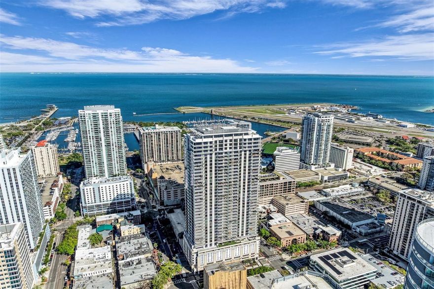 One or more photo(s) has been virtually staged. Welcome to luxury living at Art House, a striking 42-story architectural landmark in the heart of downtown St. Petersburg where modern design, premium amenities, and an unbeatable water view location create an exceptional rental opportunity.

This Southeast-facing Dali residence offers 2 bedrooms, 2.5 bathrooms, and a private den, thoughtfully designed to deliver comfort, elegance, and functionality. The expansive private terrace captures stunning views of Tampa Bay, the St. Pete Pier, Albert Whitted Airport, and the vibrant downtown skyline—providing the perfect setting for morning coffee, evening relaxation, or outdoor entertaining.

The open-concept floor plan seamlessly connects the living, dining, and kitchen areas, creating a bright and inviting space enhanced by floor-to-ceiling glass sliders and abundant natural light. The chef-inspired kitchen features premium JennAir appliances, sleek European-style cabinetry, and elegant finishes throughout. The primary suite offers a spa-inspired bathroom retreat, while the second bedroom includes its own en-suite bath for added privacy. A versatile den with a privacy door is ideal for a home office, media room, or guest space.

Additional features include a spacious walk-in laundry room, a powder room for guests, and an oversized terrace designed for seamless indoor-outdoor living.

Residents of Art House enjoy a full-service, resort-style lifestyle with a 24-hour staffed lobby, concierge services, and valet or self-parking for residents and guests. The exclusive Cloud 9 amenity level offers a resort-style pool with cabanas and spa, fire pit lounges, fitness and yoga studios, luxury wellness spa, private dining and club rooms, theater, game lounge, business center, guest suites, and pet-friendly amenities.

Ideally located in downtown St. Petersburg, this residence provides exceptional walkability to waterfront parks, marinas, fine dining, shopping, and cultural attractions.

This residence is offered unfurnished and includes two assigned adjacent parking spaces.

Schedule your private tour today and experience elevated waterfront living in one of St. Petersburg’s most sought-after luxury towers.