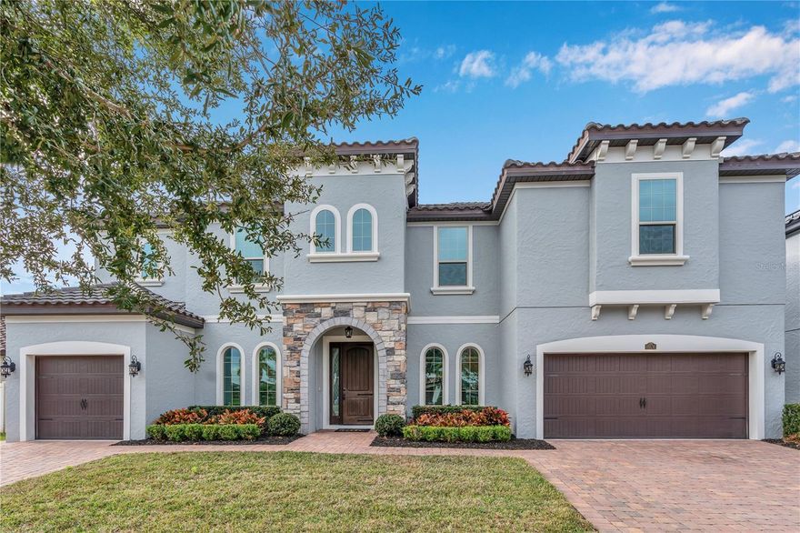 Set within Winter Garden’s desirable Twinwaters community, this expansive residence blends Mediterranean-inspired architecture with modern comfort, energy efficiency, and thoughtful upgrades throughout. Offering 5,177 square feet of living space and 6,132 total square feet under roof, the home provides six bedrooms, five full bathrooms, generous gathering areas, and an outdoor setting designed for privacy and relaxation.
A stone-accented entry welcomes you into light-filled interiors where tall ceilings and open living spaces create a natural flow throughout the main level. At the heart of the home, the upgraded kitchen features premium KitchenAid appliances, extensive quartz counter space, abundant cabinetry, and a layout that streamlines both everyday living and effortless entertaining. Retractable screens enhance the connection between indoor living spaces and the outdoors, allowing fresh air while maintaining year-round comfort. 
Two primary suites—one on each floor—offer unmatched flexibility for multigenerational living, extended guests, or a private retreat separate from the home's rhythm. Both suites include spacious bedrooms, well-appointed bathrooms, and generous wardrobe storage. New carpet elevates comfort on the second level, where additional bedrooms and a loft-style living area provide room for work, relaxation, or recreation. Thoughtful convenience continues with laundry rooms on both levels.
The home prioritizes efficiency with a suite of meaningful upgrades. Fully paid-off solar power significantly reduces long-term operating costs, while WiFi-enabled thermostats provide precise climate control throughout. A new HVAC system installed in 2025 and energy efficient appliances enhances performance and peace of mind.
Outdoor living is a central focus. A private luxury pool anchors the fenced backyard, creating a serene retreat bordered by manicured landscaping. The covered lanai extends the living space outdoors, and with retractable screens, it becomes a comfortable setting for dining, lounging, or gathering in every season.
The property also features a distinctive three-car garage configuration, with a single-car garage on the left side of the home and a two-car garage on the right, offering flexible parking, storage, or workshop space. Mediterranean-style arched windows, a tile roof, and balanced architectural proportions contribute to strong curb appeal and timeless character.
Positioned on a 0.20-acre lot, the residence benefits from a well-established community known for convenient access to top-rated schools, parks, trails, shopping, dining, and the vibrant lifestyle of Downtown Winter Garden and Horizon West. Major roadways connect the area to Orlando’s business, medical, and entertainment centers, offering a lifestyle that is both refined and practical.
With its impressive scale, versatile layout, energy-efficient systems, and beautifully maintained condition, this Twinwaters home presents an exceptional opportunity to experience modern living in one of Winter Garden’s most desirable settings.