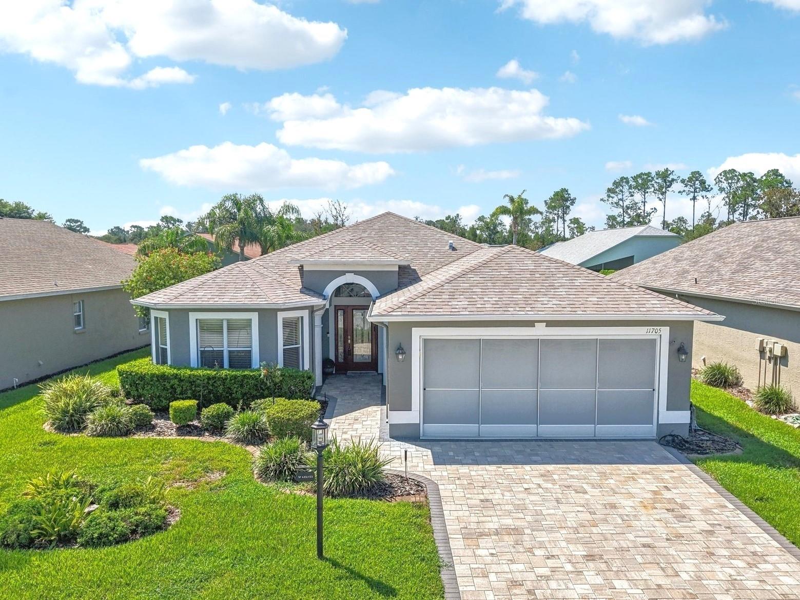 One or more photo(s) has been virtually staged. Welcome to Heritage Pines—where easy living meets Florida charm! This beautifully maintained home comes with peace of mind thanks to a brand-new roof and fresh custom pavers that add a polished touch to the driveway and walkway. Step inside and you’re greeted by the open floor plan, thoughtfully designed to make everyday living and entertaining feel effortless. Gorgeous tile and laminate flooring throughout. The kitchen overlooks the spacious living and dining areas, and is equipped with granite countertops and a convenient breakfast bar. An alcove off the kitchen serves as a cheery breakfast nook. For larger gatherings, the large dining area provides ample room. Large sliders lead to your sunny Florida room—perfect for relaxing or hosting friends.
The primary suite is roomy and relaxing, with a walk-in closet and ensuite featuring dual sinks, a walk-in shower, and plenty of storage. Two additional bedrooms and a full guest bath give you flexibility for visitors or hobbies. A dedicated laundry room with pocket doors keeps things tidy and out of sight.
This home is high and dry—not in a flood zone! Located in the ''Maintained'' 55+ Village of Heritage Pines, where yard work is off your plate and fun is on the calendar. Enjoy access to a clubhouse packed with amenities: heated pool and spa, lighted tennis and pickleball courts, fitness center, on-site dining, craft and hobby spaces, and more. Near the Gulf for beach days, boating, and fishing, and just a short drive to Tampa and Clearwater.
This one checks all the boxes—you’ll want to see it for yourself!