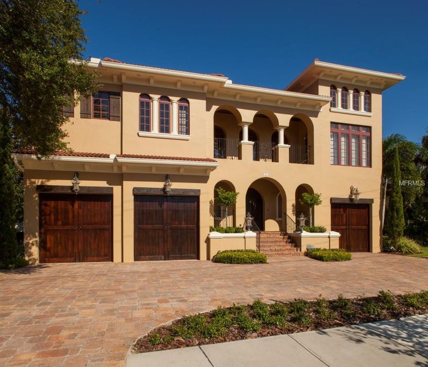 This is waterfront living at its finest in one of Tampa's most desirable neighborhoods! Upon entering you have a beautiful view of the water & an incredible open foyer w/ 25' ceilings & a beautiful hand crafted staircase with a wrought iron railing. Midway up the front stairway you will find an office/den,(12x12), with 18' ceilings & wood floors. The bedrooms are all en suite w/ one bedroom downstairs. The floor plan is perfect for entertaining inside & out! The kitchen & family room open onto 2 covered porches:one with a fireplace, tongue & groove ceiling, & a large seating area. The other porch has retractable screens and an outdoor kitchen w/ ice maker, gas grill, refrigerator, & sink. Both porches overlook the heated saltwater pool & canal with dock and a 16,000# boat lift. Just seconds to the open bay with protected canal front you can enjoy boating, fishing, or just relax! You will love creating meals in the chef's kitchen where nothing has been left out...from the Wolf 6 burner stove top w/ double ovens, decorative sub zero plus double refrigerator drawers, warming drawer, and the built-in Miele coffee bar. The center island has a gorgeous Butcher block top w/ a rich stain. Everyone will appreciate the second floor bonus room with sliders onto the covered patio w/ views of downtown Tampa and the water. The 3rd story observation patio is perfect for watching the sunsets, enjoying our beautiful downtown skyline and checking out Bayshore Blvd. and the open bay!