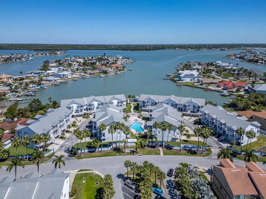 Carefree Beach Living can be YOURS at Tides Village! This spacious townhome is located in the gated community of The Villages of NRB - Yacht Club and has been extremely well-maintained. Over 2,500 square feet of living space on 3 levels includes lots of storage area as well as comfortably-sized rooms and an open plan on the main living level. The end unit location provides extra windows on the west-facing walls, inviting natural light. The first level includes an oversized 2-car garage with lots of storage space, a private patio, entry foyer and elevator. The second level is open, with hard wood flooring, and combines dining, living, kitchen and extra space for a library, media area or fitness area, and a generous covered balcony for al fresco dining or just relaxing. Spacious eat-in kitchen, complete with coffee nook and desk, and a cozy balcony to enjoy breakfast or tea. Recently remodeled kitchen upgrades include quartz countertops, glass tile backsplash, real wood soft-close cabinetry, microwave drawer, Bosch oven and induction cooktop, Bosch dishwasher; newer LG fridge.
The third level is a split bedroom plan consisting of the primary bedroom suite and two additional bedrooms, second full bath, laundry closet with sink, and two balconies. All bedrooms feature attractive transom lights and luxury vinyl plank flooring. The primary bedroom includes a large walk-in closet/dressing room, a spacious bath with dual sinks (brand new glass shower enclosure), and a private balcony with a partial water view! The two additional bedrooms have ample storage space as well and share a covered balcony overlooking the community. 
Other items of note include a Reme-Halo air purification system, water softener and water filtration system. New water heater 2025. Storm rated windows and doors throughout with the exception of primary bedroom sliders, which have roll down storm shutters.
This gated community consists of 28 townhomes located in the heart of North Redington Beach, with a heated swimming pool and spa, beautifully maintained common areas and a waterfront dock. Yacht Club is only steps away from local restaurants, town tennis court, and just across the street from the Gulf beaches. Priced to sell! Move-in ready! Home Warranty included!