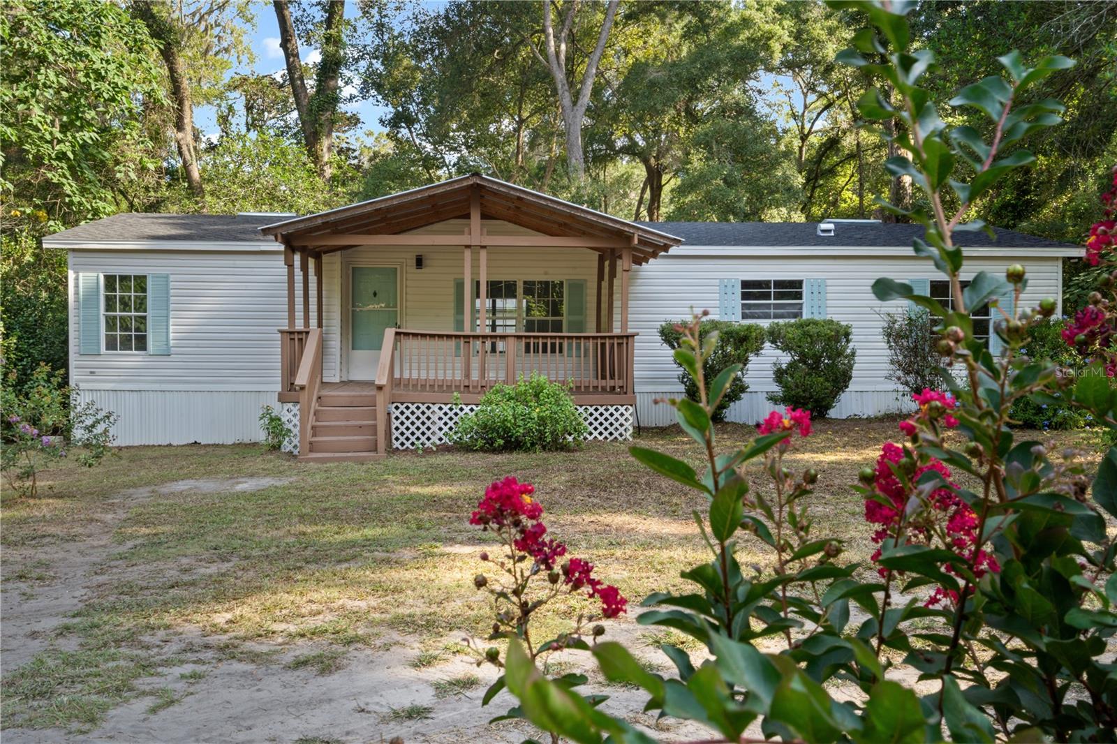 Paradise awaits you on the fully mature landscaped 3/4 of an acre with fencing. Completely high end renovation with new kitchen, new bathrooms, new fixtures, new vinyl flooring, new A/C and as if that is not enough, it already has 2 large storage sheds, one with built in shelving and the other one is set up as a workshop and a large 4 bay pole barn. Easily set up to run your business from home. Also, there's room enough to add an ADU if you would like 2 homes on the property. A little bit of country but yet close enough to town for convenience. Large covered porch for relaxing and enjoying nature and wildlife that abounds on the property.