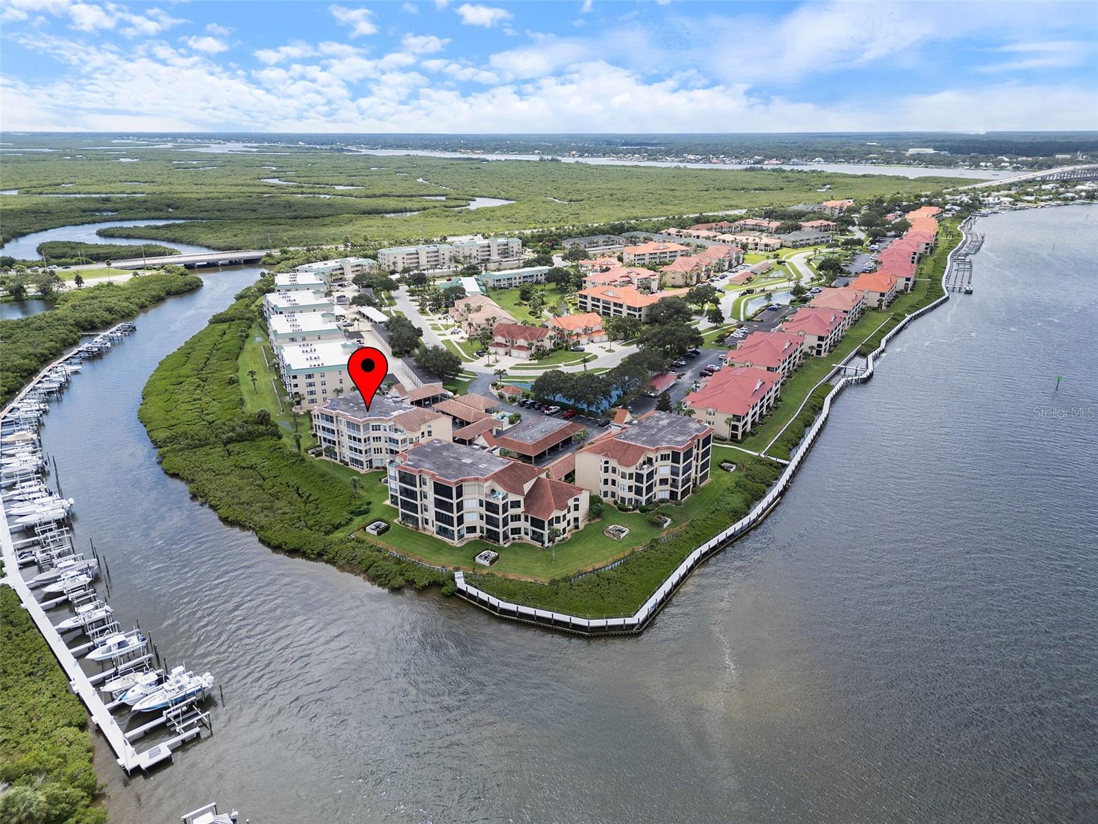 A meticulous renovation plus floor-to-ceiling water views equal Florida living at its finest. Residence #202 is located within The Pointe buildings in the Bouchelle Island community. You will enjoy waterfront living and the convenience of being close to everything you love about New Smyrna Beach. On entering this home, you are immediately drawn to the views and the open, light drenched spaces. The Open Floor Plan maximizes views of Callalisa Creek and the Intracoastal Waterway from the great room, kitchen and primary suite. The spacious great room includes the living and dining areas featuring high ceilings, impact windows and welcoming furnishings. Adjacent to the great room is the Florida Room featuring floor-to-ceiling impact windows from which you can see the draw bridge and North causeway. Its the perfect spot to watch dolphins, curl up with a book, host friends and family or ease into the day with that first cup of coffee. Also open to the great room is the gorgeous kitchen with custom wood cabinets, granite counter tops, a deep stainless sink and high end Samsung appliances. The thoughtful renovation incorporates into the kitchen the laundry area with even more storage and counter space for folding laundry or keeping out of sight your counter-top appliances. The Primary Suite also enjoys full water views and open access to the Florida Room. With a King bed, large walk-in closet, en-suite bathroom with custom vanity, leather finish granite counter top, large walk-in shower and private water closet, your private sanctuary awaits. Guests may be tempted to overstay their welcome once they see the spacious guest room with King bed and ensuite bathroom. The 2nd bathroom also opens to the living area, maintaining privacy for bedroom #2. Residence #202 enjoys a deeded carport with private adjacent storage closet. The buildings comprising The Pointe at Bouchelle Island provide the security of concrete construction. With impact glass protecting all window openings, residence #202 allows for a true lock and leave lifestyle. Bouchelle Island offers numerous amenities including fitness center, two heated pools, hot tub, tennis, pickle ball, stunning waterfront boardwalk, courtesy dock for pick up and drop off, fishing pier and an inviting tiki area for chilling and grilling. Additional, fee-based, amenities include the opportunity to lease a boat slip at the Bouchelle marina, arrange for boat & trailer storage, store your kayak or canoe and take advantage of Bouchelle’s private boat ramp. These fee-based amenities are based on availability and are separately approved and leased through the Bouchelle Island CSA. This beautifully renovated residence and Bouchelle’s resort quality amenities make for a tremendous value. Please note Buyer pays a one-time capital contribution to the Bouchelle Island Community Services Association, as set forth in the HOA Disclosure. All measurements are approximate and Buyer responsible for verifying all dimensions.