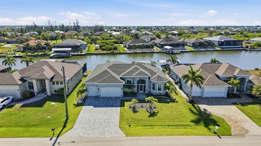 Welcome to your dream waterfront oasis in the highly desirable community of South Gulf Cove, where luxurious living meets serene natural beauty!  Come view this spectacular 2023 home built by Turn Key Custom Homes.  From the moment you arrive and step through the stunning French doors you’ll be greeted by a bright and airy great room featuring soaring tray ceilings, crown molding, and striking 5-inch baseboards.  
The heart of the home is the chef's kitchen featuring an oversized granite island, custom soft close wood cabinetry, beautiful backsplash, SS appliances, modern pendant lighting and a spacious walk-in pantry perfect for all your storage needs, all flowing effortlessly into the vibrant dining area with sliders to the lanai.
 Retreat to the luxurious primary bedroom which offers a serene haven with a lavish ensuite bath featuring a tiled Roman shower with dual shower heads, including a rain shower head, plus dual vanities and a makeup vanity, all adorned with beautiful granite countertops. The primary also features sliders that open to lanai offering a view of the canal. 
 For added convenience, a large laundry room is located just off the primary suite, making daily tasks a breeze. 
A versatile bonus flex room and/or den with a charming half-moon window and double doors offer perfect spaces for an office or a cozy guest retreat, enhancing the home's functionality. 
The guest bedrooms are strategically located on the opposite side of the home for privacy; one features a large walk-in closet complete with custom shelving and an ensuite bath with a tiled walk-in shower. 
 The expansive zero-degree tinted sliders equipped with custom remote controlled shades provide seamless access to the paver lanai.  
Step outside to your tropical oasis where the heated, saltwater pool has been strategically placed in the corner for maximum sun exposure overlooks a tranquil canal setting.  The expansive lanai features plenty of covered seating, a separate dining/grilling area and even an outdoor shower. In addition the back yard is completely fenced with a decorative black aluminum fence for the added security for your pup!   Additional highlights of the stunning home include porcelain tile throughout, impact windows, sliders and garage doors, security system, sprinkler system, custom plantation shutters and custom shades on sliders and screened in front entryway.  There is also has a whole house generator the seller is willing to negotate with the sale.   Don’t miss this incredible opportunity to experience waterfront living at its finest in South Gulf Cove!