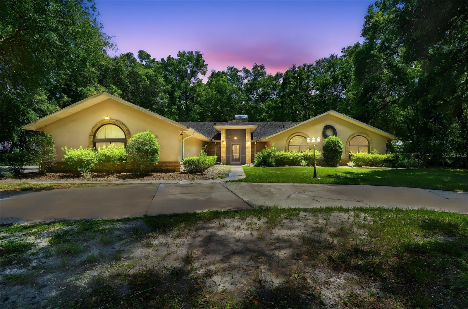 One or more photo(s) has been virtually staged. Welcome to your private retreat in Lecanto, Florida! This spacious 4-bedroom, 2.5-bathroom home offers over 3,000 square feet of comfortable living space on nearly 1.25 acres—plenty of room to relax, entertain, or simply enjoy the peace and quiet. Step inside to find soaring vaulted ceilings and an open layout that brings in tons of natural light. The kitchen is a true standout, featuring solid wood cabinets, stainless steel appliances, a center island, breakfast bar, and a dry bar—perfect for hosting or casual meals. The primary suite is generously sized and includes a walk-in closet and an en suite bathroom with dual sinks, a soaking tub, and a separate shower. Out back, enjoy Florida living year-round in the large screened-in lanai, which overlooks the beautifully maintained yard and offers serene views and privacy. With a 3-car garage, no HOA, and plenty of space both inside and out, this home combines everyday functionality with comfort and charm. Located just minutes from golf courses, restaurants, grocery stores, and the YMCA, this home gives you the perfect blend of peaceful living and convenient access to local amenities. Come see all that this unique property has to offer!