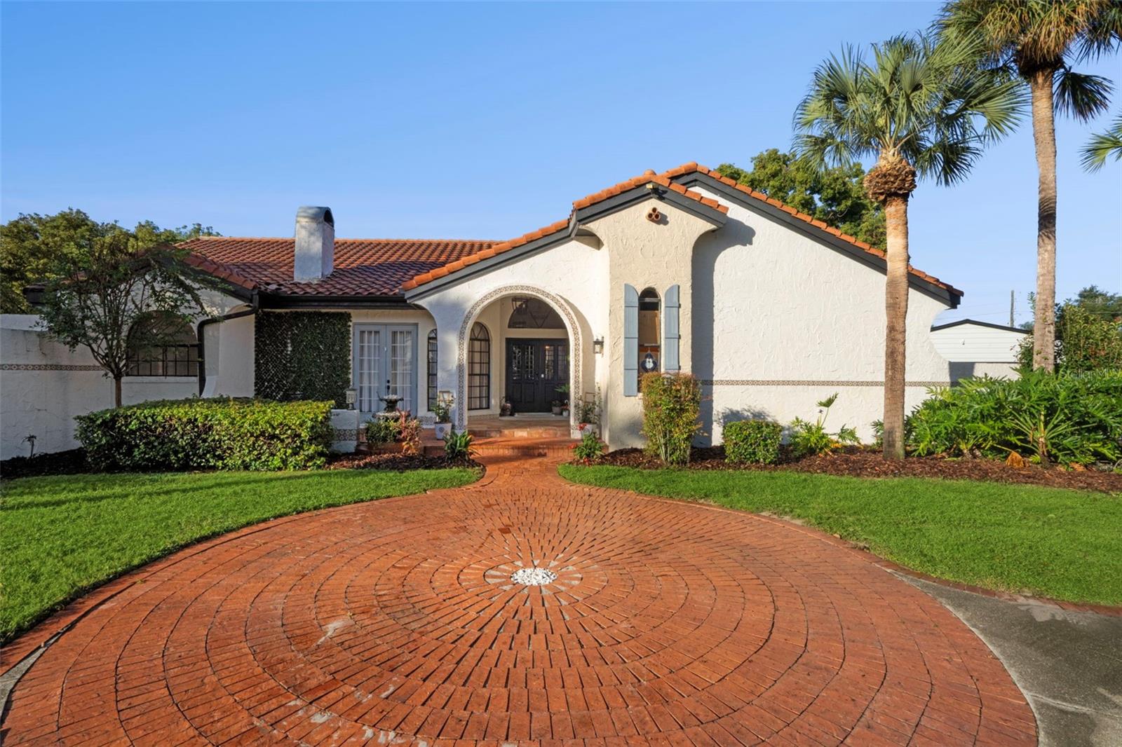 Welcome to this Mediterranean dream home tucked away at the end of a quiet cul-de-sac in Windermere, just steps from beautiful Lake Down. Sitting on over an acre of fenced land, this property is one of the most unique opportunities in the area. From the moment you arrive, the curb appeal stands out with a circular driveway that flows into a full side driveway leading to an oversized detached two-car garage—offering plenty of room for vehicles, a boat, or equipment.
The property includes both a main residence and a private guest house, or a Casita, creating the perfect setup for multigenerational living or rental income. Step inside the main home, featuring four bedrooms and three and a half bathrooms, and you’ll immediately feel the openness and see the timeless updates framed by views of the sparkling pool beyond. Elegant ceiling beams and luxury vinyl plank flooring run throughout. To the left, the formal living room welcomes you with a wood-burning fireplace and extends toward the pool into a bright entertainment area highlighted by a wet bar and accent wall. The main living area in the front of the house also features a stylish full bathroom. 
The kitchen opens to the main living space and features updated soft-close cabinetry, stainless steel appliances, and a six-burner ZLINE gas range with a custom wood hood. A large center island provides additional storage with cabinets on all sides, making it both functional and stylish. Between the kitchen and the breakfast nook, there’s plenty of room for a full dining table, giving you flexibility for both casual and formal gatherings. The breakfast nook is set in its own cozy corner, extending from the open living area and filled with natural light.
The primary suite, located on the northeast side of the home, is spacious enough for a reading nook or home office, with two sliding doors leading to the pool patio and two walk-in closets. The primary bathroom features a double vanity, a jetted tub, and a walk-in glass shower, plus a rare private courtyard for moments of tranquility.
A large bonus room, with a half bath, offers flexible use—ideal for a playroom, craft space, movie room, or even a second primary suite. The bonus room has a powder bathroom. Toward the back of the home are three additional bedrooms and a fully renovated bathroom with a dual vanity and other modern finishes. One of these bedrooms has direct access to the pool patio, where you’ll find a wet bar with a wine fridge and sink, making entertaining easy.
The lanai is fully screened and showcases a heated pool and spa. The entire pool area, including the decking, resurfacing, and pool equipment, has been recently upgraded, and all pool functions can be controlled via Bluetooth. A convenient storage room adds extra utility.
Across the expansive backyard with Oak trees, sits the charming Casita—complete with a kitchenette, bedroom, and full bathroom. It’s ideal for guests, family, or even as an income-producing unit. The current owner leases it for $1,300 per month, adding incredible flexibility and value to the property.
Combined, the main residence and Casita offer five bedrooms and four and a half bathrooms. Located minutes from downtown Windermere and Dr. Phillips, and just a short drive from Orlando’s world-famous attractions, this rare property blends privacy, functionality, and luxury in one exceptional package.
Schedule your private showing today.