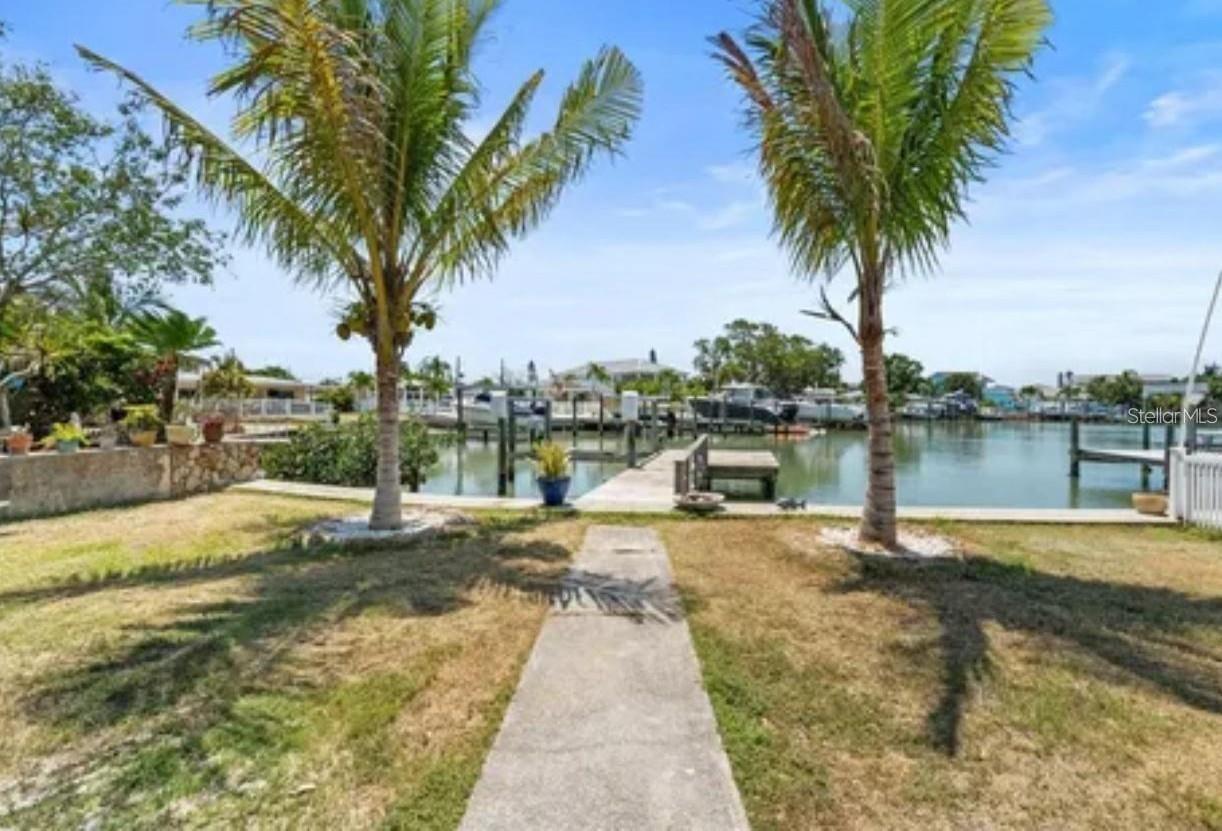 Development/Build Opportunity – Located on Madeira Beach’s coveted W Parsley Drive, this waterfront lot offers the perfect canvas for a custom luxury build. The existing structure holds no value and should be considered a tear-down, making this a true land opportunity. The lot includes a private dock and sits on a no-bridge canal, giving boaters direct passage to the Intracoastal and Gulf of America. Just a short stroll or bike ride brings you to Madeira Beach’s famous sandy shoreline, or take your boat out for a sunset cruise to the Gulf. Dining and shopping at John’s Pass are minutes away, while Tampa International Airport and Downtown St. Petersburg are within easy reach. Whether you’re a builder, investor, or homeowner ready to design a one-of-a-kind residence, this property is a rare opportunity in a prime location.