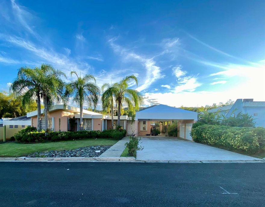 Exclusive gated residence offering privacy, controlled access, and expansive interior and exterior living areas. This one-story home features approximately 2,569 square feet of living area with a welcoming foyer, two separate living rooms, formal dining room, and spacious kitchen. The property includes four (4) bedrooms, three (3) full bathrooms, and three (3) half bathrooms in total. An elegantly built extension with high ceilings provides additional family room space, informal dining area, and a dedicated office. Double and extended carport. Outdoor living includes a 25’ x 29’ covered terrace with high four-slope ceilings, ideal for entertaining. The 1,084 square meter lot also includes a separate three-level concrete structure consisting of: (1) a 24’ x 54’ storage room with half bath, (2) a large additional terrace ready for renovation with kitchen areas and two half baths, and (3) an open terrace with exceptional green views. Property equipped with power generator and water cistern. Property is being sold “As Is.” Pre-qualification letter or proof of funds required prior to scheduling showings.