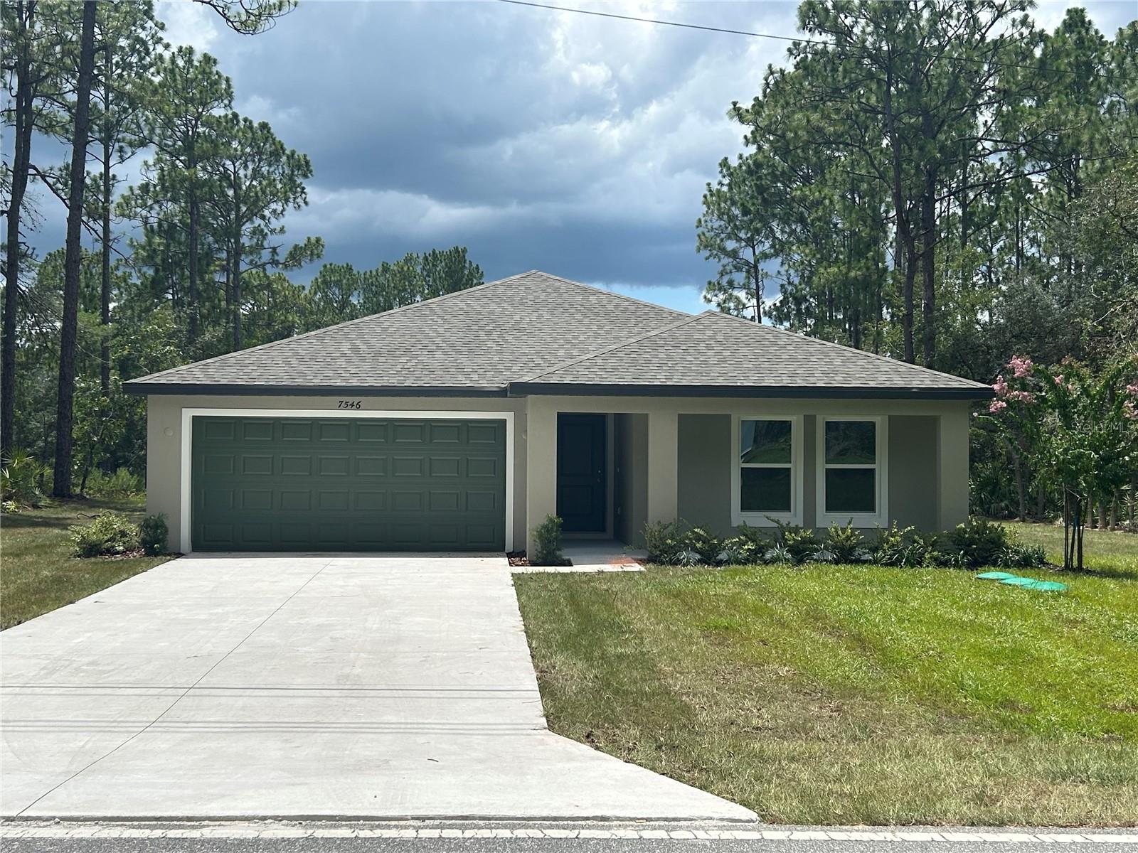 PRICE REDUCTION - LIMITED TIME ONLY! Closing Cost Assistance provided with use of Builder Preferred Lender. NEW CONSTRUCTION – MOVE-IN READY! This brand-new home offers a generous lot and a well-designed layout suited for various living needs. This residence reflects thoughtful craftsmanship and attention to detail throughout. Upon entry, you'll find durable and attractive Luxury Vinyl Plank flooring and a spacious family room accented by a tray ceiling, creating both openness and warmth. The modern kitchen features custom white shaker cabinets with soft-close drawers, stainless steel appliances, a roomy pantry, and white quartz countertops that extend into the bathrooms. A covered lanai, built under the main roofline, offers a comfortable outdoor area for relaxing or entertaining. Additional features include: Concrete block construction, Double-pane energy-efficient windows, Garage door opener with remotes, and a 10-year structural warranty provided by the builder. This move-in-ready home combines functional upgrades and modern finishes in a peaceful setting.