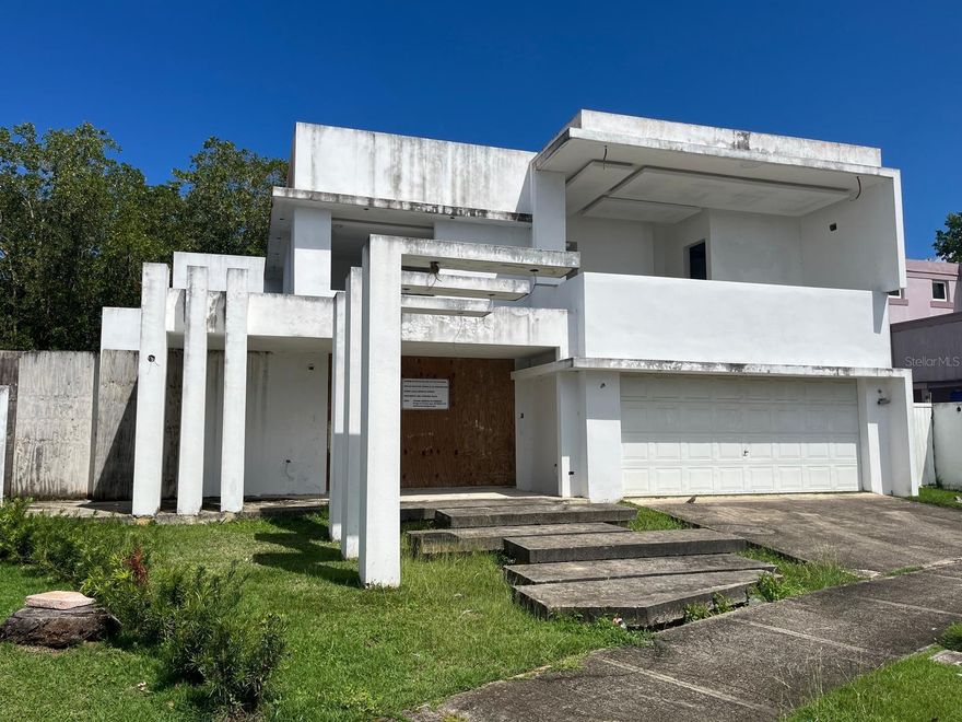 Located in the exclusive community of Mansiones de Vistamar Marina in Carolina, this property represents a rare opportunity to complete a stunning modern luxury residence in one of the most desirable areas of the region. Originally built in 2005, the home sits on a 4,921.58 sq. ft. lot with approximately 3,446 sq. ft. of interior living space, distributed over two levels. The residence is designed to include 4 bedrooms and 4.5 bathrooms, offering spacious living areas and a thoughtful layout ideal for modern living and entertaining. The property is currently being offered as a shell, allowing the future owner to complete the finishes and customize the residence according to their own vision and style. The architectural concept was designed with modern living and smart home functionality in mind, incorporating several thoughtful structural and design features that significantly elevate the property’s potential. Architectural and Design Features Striking modern architectural entrance with floating front steps Three front pergolas enhancing the contemporary design Decorative water wall feature at the entrance creating an elegant arrival experience Designed to function as a Smart Home Floor electrical outlets strategically installed to avoid visible wall cabling Completely new kitchen area designed with gas connections and water lines already in place Large walk-in pantry ideal for storage and organization Interior Layout Highlights 4 Bedrooms | 4.5 Bathrooms Dedicated home gym area Front space ideal for a man cave or entertainment room Primary suite with two independent walk-in closets, designed separately for him and her Two laundry rooms for convenience — one on the first level and another on the second level Outdoor Entertainment Concept The backyard was planned to function as a private resort-style entertainment space, including: Area designed for a swimming pool Full outdoor bathroom serving the pool area Dedicated space for an outdoor bar and entertainment area Area prepared for barbecue and outdoor TV installation Spacious terraces ideal for gatherings and relaxation Privacy and Natural Surroundings One of the most attractive features of this property is the absence of rear neighbors, as the backyard borders a natural mangrove area, providing privacy and a peaceful natural setting. There is also natural water access behind the property, allowing activities such as paddleboarding or kayaking to nearby marina areas. Exceptional Value Potential Completed homes with similar luxury features in this area have reached values close to $1.8 million, highlighting the significant upside potential of this property once finished. The monthly HOA fee is approximately $125, providing access to the community amenities and maintenance of the development. This property is ideal for a a visionary buyer or investor looking to complete a spectacular contemporary residence in one of Carolina’s most exclusive communities..