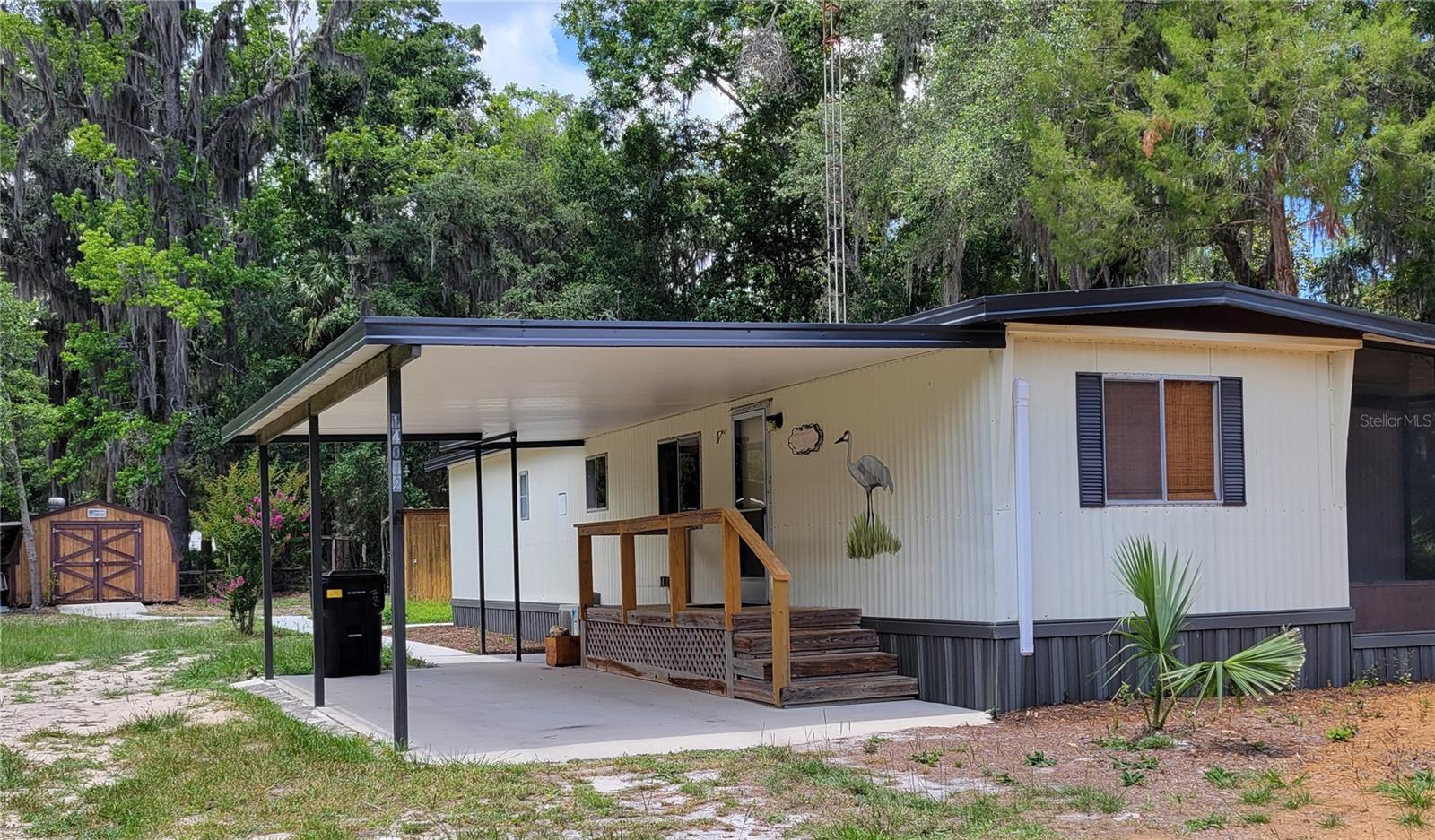 CROSS CREEK Nestled in the unspoiled heart of Florida, this beautiful 2 bedroom, 1 & 1/2 bath manufactured home nicknamed The Sandhill has been completely remodeled by meticulous craftsmen with an artistic eye for design and beauty. Upgrades throughout the home include luxury vinyl floors, new carpet and fresh paint. Additionally, a brand new economical mini split AC system, newly installed electrical panel and upgraded outlets ensure comfort, safety and economy. The kitchen features new, whitewashed butcher block countertops, and new stainless-steel sink, stove and refrigerator. Custom ceramic tiles by designer Angela Harris Dunmore add a custom tropical flavor to the kitchen walls. A raised Spanish tile is carried into both bathrooms to complement new vanities, lavatories and even a soaker tub. Located on a third of an acre lot (double lot) in a small and friendly community, the home boasts two enclosed screened porches, plenty of space to grow a vegetable or flower garden, and two carports for vehicles or boats. An added bonus: It is located on a paved street and is on city water and sewer, which many such rural properties in Cross Creek are not. Whether you're searching for a primary residence, a weekend retreat, or an investment opportunity, this home can fill the bill. Like the magnificent sandhill cranes it is named after, this home is a part of Cross Creek. And you will have the best of two worlds: the peace and quiet of country living less than five minutes from some of the best fishing in Florida on Orange Lake (500 acres) and Lochloosa Lake (5, 700 acres) but less than 30-minutes away from bustling Gainesville with the University of Florida and its world class medical facility UF Health. Renowned author Marjorie Kinnan Rawlings immortalized Cross Creek in her books. Her residence, now a state park, is less than 3 minutes away, as is the legendary Cracker cuisine restaurant The Yearling, named for her most famous novel and a favorite with locals as well as visitors. She fell in love with Cross Creek. Perhaps you will too. Call today for an exclusive look at this unique and affordable treasure in one of Floridas loveliest regions.