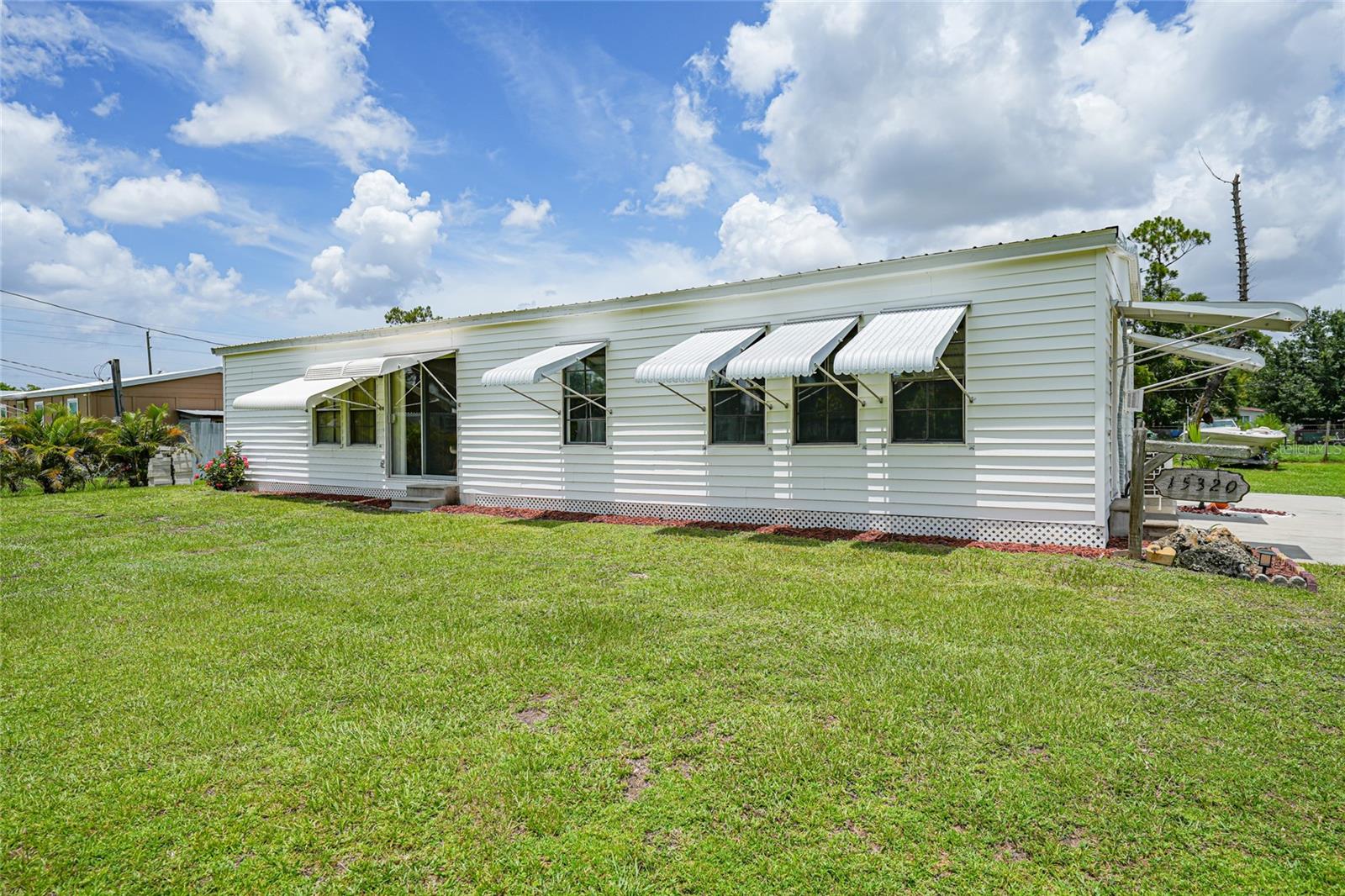 Opportunity Knocks in Punta Gorda! Discover comfort, flexibility, and value in this unique 3-bedroom, 2-bath home at 15320 Mango Drive. Built in 1974 and thoughtfully updated, the home features a NEWER metal roof, NEWER hot water heater, NEWER whole-home water filtration system, NEWER electrical panel and breakers, hurricane shutters for peace of mind, and a NEWLY renovated primary bathroom—making it completely move-in ready with peace of mind for years to come. Offering 1,164 square feet of total space, this home presents a versatile layout with two kitchens and two living rooms, ideal for multi-generational living, guest accommodations, or a private in-law suite or rental unit. Inside, you’ll find central air and heat, ceiling fans, an eat-in kitchen, and low-maintenance tile and laminate flooring throughout. The property is serviced by well water and a septic system, which was last pumped in 2025. Major systems have already been upgraded for modern efficiency and convenience. Set on a generous 12,221 sq ft lot, the home also includes a carport, paved driveway, rain gutters, and a large storage shed with a built-in workshop—perfect for projects, hobbies, or additional storage. Sliding patio doors enhance the indoor-outdoor flow, and hurricane shutters provide added protection during storm season. Conveniently located just minutes from shopping, dining, golf courses, marinas, parks, and historic downtown Punta Gorda, this home offers unbeatable value and flexibility. Whether you're seeking a primary residence, seasonal getaway, or income-producing opportunity, 15320 Mango Drive is a smart choice you don’t want to miss.