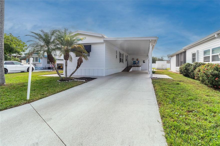 Welcome to your slice of paradise in the charming Leisure Lake Co-Op community! This exceptional mobile home offers the perfect blend of comfort and convenience for those seeking an active 55+ lifestyle. The thoughtfully designed 1,160 square foot residence features a practical split floor plan with two spacious primary bedrooms, each boasting private ensuite bathrooms and generous closet space. The converted lanai serves as a versatile third bedroom with its own private entrance and mini-split air conditioning unit, complete with a clever barn door that conceals the laundry area. The heart of the home showcases an inviting open-concept design where the kitchen, dining, and living areas seamlessly flow together, creating an ideal space for entertaining family and friends. Recent updates demonstrate exceptional care and attention, including a lifetime warranty roof, energy-efficient windows, modern appliances, luxury vinyl flooring, and a tankless hot water heater. These improvements provide peace of mind and years of worry-free living ahead.  The expansive lot offers endless possibilities for outdoor activities and gatherings, complemented by a two-car carport and dual storage sheds for all your recreational equipment. The golf cart-friendly community features abundant amenities including a sparkling pool, sports courts, welcoming clubhouse, and fully-equipped fitness center.  Your monthly homeowners association fee covers lawn maintenance, water, sewer, and trash services, allowing you to focus on enjoying the Florida lifestyle. The prime location provides easy access to shopping, dining, and the pristine beaches of Anna Maria Island, with convenient connections to major highways for exploring all that Florida has to offer.