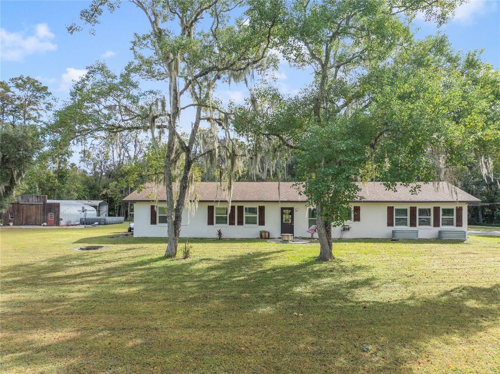 Modern Farm Retreat on 5 Acres in Gated Happy Trails – Kissimmee, FL
Discover the perfect blend of country living and modern comfort in this stunning 3-bedroom, 2-bath home located in the exclusive gated section of Happy Trails. Nestled on 5 private acres, this over 2,000-square-foot residence offers serenity, space, and sophistication just minutes from the attractions, dining, and shopping of Kissimmee.
Step inside and be welcomed by a beautifully renovated interior showcasing a modern farmhouse design—bright, open spaces, elegant finishes, and top-of-the-line appliances throughout with Quartz Countertops and extra large farm sink. Ton of storage with two walk in pantries. The home’s layout flows effortlessly, ideal for both everyday living and entertaining.
Outside, enjoy your very own private pond with a tranquil fountain, perfect for relaxing afternoons or scenic evenings under the stars by your two fire pits. The property also features a 30x50 workshop/garage, RV carport with hookups, and a fenced front and side line with a private gate for added security and convenience. Bring your livestock—there’s even an established chicken coop ready for your feathered friends and a separate garden shed.
With plenty of room to expand, garden, or build additional structures, this estate offers limitless potential for anyone seeking a self-sustaining lifestyle without compromising modern luxury.
Enjoy the peace and privacy of country living while remaining close to everything Central Florida has to offer. This one-of-a-kind property is ready to welcome you home!