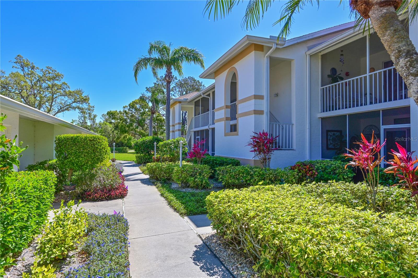 This truly loved condo has been the vacation place for these homeowners for many years. They have enjoyed the Florida lifestyle at Tara Golf and Country Club, the warm weather and the beauty and comfort of their updated condo. They never worried about storms ever since they out in all new hurricane sliders and windows. The lanai that overlooks the golf course (10th hole) has an automatic roll down hurricane shutter. The remodeled kitchen has wood cabinets, quartz counters and GE appliances. Sliders out to the screeded lanai for extra dining. Vaulted ceilings in the living/dining area create an open airy feeling with hardwood floors and sliders out to the screened in lanai. Home office/den has built-ins for all your files, papers and sundries. Split floor plan has the Primary bedroom in the back of the home with views of the golf course and sliders that lead out to the lanai. Two walk-in closets. En-suite bath with newer walk-in shower and vanity. Second bedroom has large closet. Full bath right outside the door. Laundry closet . One car garage Class A membership comes deeded to the property. Golf, Tennis, Pickle Ball, Full Fitness Center Community Pool and Spa, Bocce, and the best dining in the busy clubhouse. Golf course was renovated in 2023, New Racquet Center being built with 5 new Pickle Ball courts an the Clubhouse is to be remodeled in 2025. No assessments to the members. No CDDs. Great location west of I 75, close to airports, great dining, shopping and the best beaches in the Sarasota/Bradenton area. This home comes Turn-Key Furnished and has a One Year Home Warranty!!! Welcome to Taradise.
