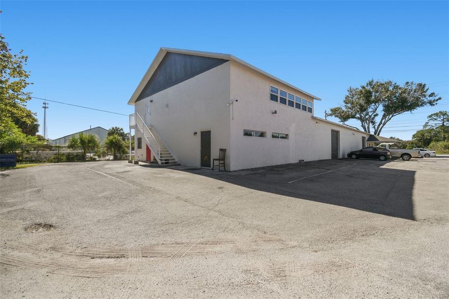 A rare mixed-use opportunity in the City of Port Richey, North Tampa Bay. Zoned C3, this versatile commercial building delivers the ideal combination of office, warehouse, and residential space—perfect for an owner-user, investor, or business needing flexibility and climate-controlled functionality. The first floor offers multiple entry points, dedicated 5 office areas, a full bath and a half, a kitchenette, and large open sections that adapt beautifully for light manufacturing, storage, assembly, training, or additional office build-out. The warehouse area features 2 10ft tall overhead doors, excellent ceiling height, abundant natural light, and air-conditioned space for clean, temperature-controlled operations. The second floor adds tremendous value with a fully finished apartment featuring two bedrooms, a full bath, a spacious living area, and a remodeled kitchen with granite countertops and stainless steel appliances. It works perfectly for an on-site manager, executive suite, meeting space, or administrative offices.
This property is also ideal for lifestyle-driven buyers. The massive warehouse space can become the ultimate recreational showroom for boats, jet skis, cars, or hobby collections, the dream space to store all your toys. With the Cotee River and nearby boat ramps just around the corner, you have quick access to water activities, marinas, and waterfront restaurants. Ridge Road connects directly to the Veterans Expressway/Suncoast Parkway, offering easy north–south commuting to Tampa, the airport, and surrounding areas. Additional highlights include abundant parking for at least 20 vehicles, easy drive-around access, three-phase power, and a central location near US-19, Ridge Road, SR-52, and SR-54. A perfect fit for businesses needing clean, climate-controlled space, storage and distribution capability, office and warehouse flexibility, or a unique mixed-use setup with on-site living or workspace potential.