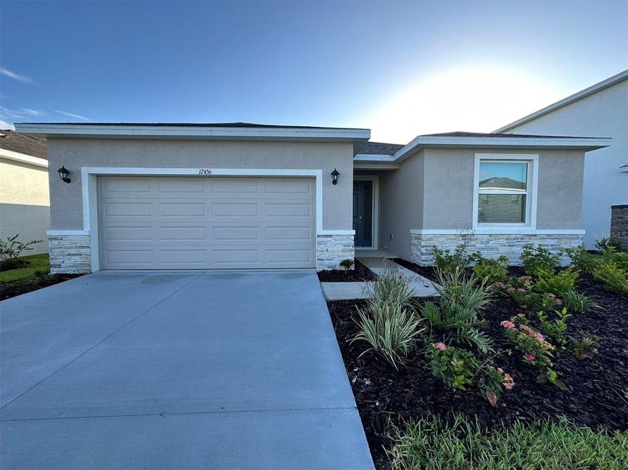 Move-in June 1st! This  Pond view residence in the Bella Largo community of Parrish, FL, is a beautiful single-story home featuring 4 bedrooms and 2.5 bathrooms. The spacious, open-concept living room creates a seamless flow throughout the house, perfect for both everyday living and entertaining. The updated kitchen is equipped with stainless steel appliances, granite countertops, and a large center island. The primary bedroom serves as a true retreat, featuring a walk-in closet and an en suite bathroom complete with a soaking tub and a walk-in shower. The home also includes a two-car garage and a large backyard with a screened patio.