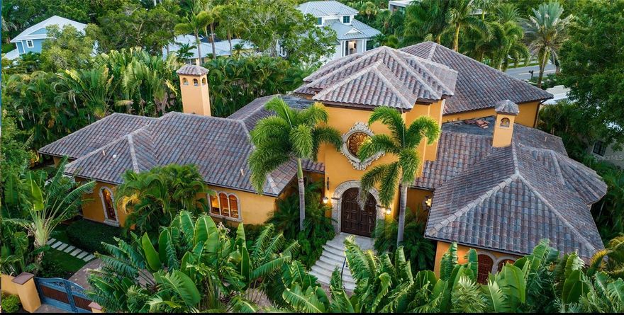 Auction Property. AUCTION BIDDING OPEN: Bidding ends 6/26. Previously Listed $3.95M. Current High Bid $2M. No Reserve. This gorgeous Mediterranean-style estate is just minutes from downtown Sarasota near Selby Gardens. This beautiful home has refined finishes and walled-in privacy and is located in the vibrant Avondale community. The property was designed by Kurt Lucas with a luxurious Old World style throughout. The interior boasts soaring ceilings, Peruvian walnut parquet floors, and stained glass mandala windows. The spacious chef’s kitchen has high-end appliances, a butler’s pantry, and a stunning Brazilian cherry wood island. The family room flows through French doors out onto the terrace with rose-antico columns and views of the garden. The formal dining room has sophisticated birch and Venetian marble paneling and trim. Entertain outdoors on the spacious stone patio or curl up in the media room for movie night. Escape to the primary suite with French trim and a Roman marble bath in the spa-like en-suite. The three additional bedrooms feature pine-stained floors, jetted marble baths, iron balconies, and custom closets.