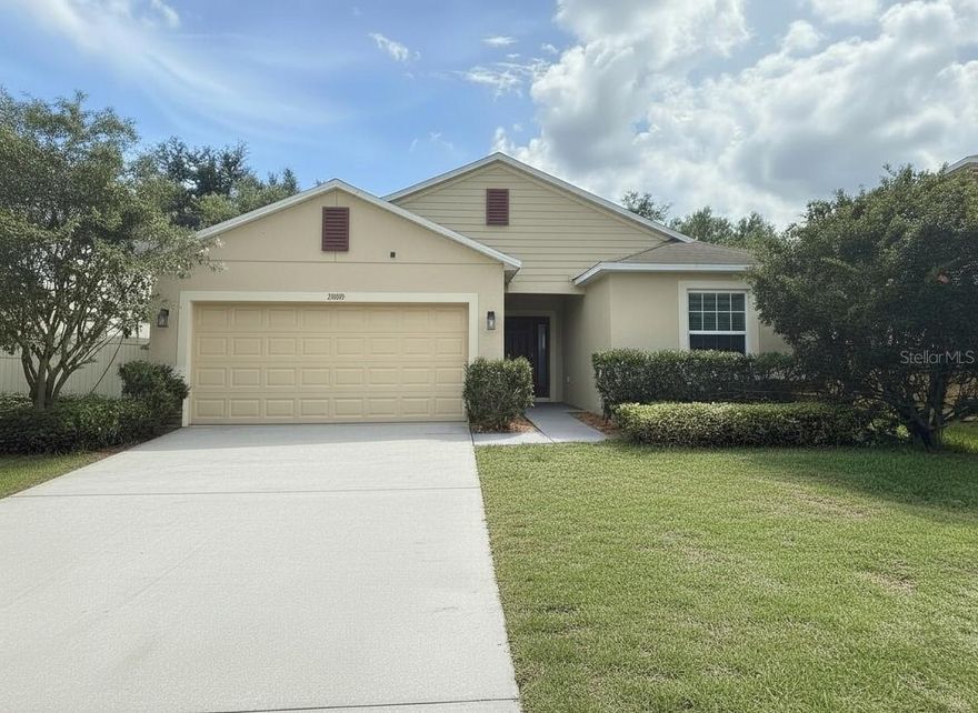 One or more photo(s) has been virtually staged. Welcome to 5909 Windsong Oak Drive NEAR the quiet culdesac in the very back of this quiet community, in the desirable Windsong at Leesburg community—where modern comfort, convenience, and Florida living come together beautifully. 

This move-in-ready home offers 1,875 square feet of thoughtfully designed living space featuring attractive stone accents, durable block-and-stucco construction, energy-efficient double-pane windows, and a spacious two-car garage.

Step through the impressive foyer and discover an open-concept floor plan highlighted by large ceramic tile flooring, abundant natural light, and spacious gathering areas perfect for entertaining or everyday living. The heart of the home is the oversized kitchen featuring rich espresso cabinetry, granite countertops, stainless steel appliances, abundant prep space, and a large dining area ideal for family dinners and holiday celebrations.

The expansive living room flows seamlessly to the large covered lanai through oversized sliding glass doors, creating the perfect indoor-outdoor lifestyle. Whether you're enjoying your morning coffee, relaxing after work, or hosting friends and family, this inviting space is designed to be enjoyed year-round.

The oversized primary suite serves as a private retreat with plenty of room for a sitting area, a huge walk-in closet, and a luxurious ensuite bath featuring dual vanities, solid-surface countertops, a soaking tub, and a separate walk-in shower. Secondary bedrooms are with comfort and privacy, while the oversized laundry room provides additional storage and functionality.

Beyond the home itself, Windsong at Leesburg offers exceptional community amenities with low HOA fees. Residents enjoy a beautiful community pool, covered seating and gathering areas, and a playground, creating the perfect setting for relaxation, recreation, and neighborhood gatherings.

Location is another standout feature. Conveniently situated near Publix, shopping, restaurants, medical facilities, and daily conveniences, everything you need is just minutes away. Outdoor enthusiasts will appreciate the close proximity to public boat ramps and the area's beautiful lakes, providing endless opportunities for boating, fishing, kayaking, and waterfront fun.

Commuters will love the easy drive to Clermont, Minneola, and surrounding Central Florida destinations, while wine enthusiasts can enjoy nearby weekends at Lakeridge Winery, one of Florida's premier wineries known for its scenic vineyards, festivals, and live entertainment.

If you've been searching for a move-in-ready home in Leesburg with granite countertops, stainless steel appliances, an oversized primary suite, covered lanai, low HOA fees, community pool, playground, and convenient access to shopping, boating, and Clermont, then 5909 Windsong Oak Drive is the opportunity you've been waiting for.

Schedule your private showing today and discover why this exceptional home stands out from the competition.