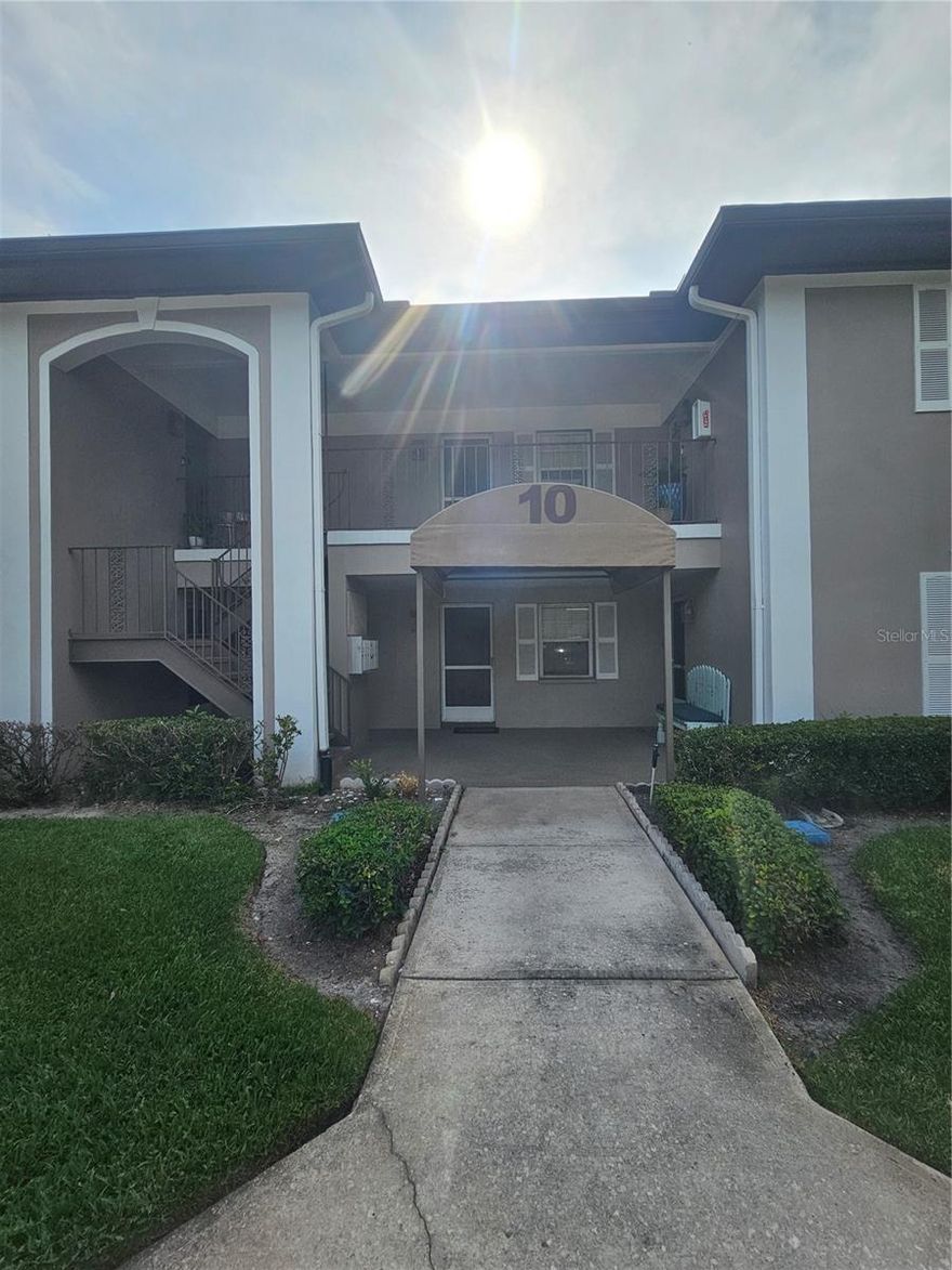 Welcome to this ground-floor residence in the well-maintained Bay Oaks Condo community. Nestled in Building 10, located in a NO-flood zone, this unit offers privacy and peace of mind in a quiet setting. Less than 2 years old AC unit/water heater. This unit features a bright, open floor layout with wood-look tile throughout the main living areas.  The generously sized bedroom includes a walk-in closet, and the effective bathroom tile and vanity. A washer and dryer are included, and there is plenty of storage throughout the unit. Enhancing the home is a windowed, screened-in solarium—ideal for year-round use and easily accessible from both the living room and bedroom. Additional highlights include a covered, reserved parking space directly in front of the unit and plenty of guest parking. Bay Oaks is a quiet, ALL-ages, pet-friendly community offering mature oak trees, lush landscaping, a community pool, and a pond with a fountain. Shopping is located directly across the street, and the $470/month HOA fee covers cable, internet, sewer, trash, pool, and grounds maintenance. (One or more photos are AI Enhanced - Seller is motivated)