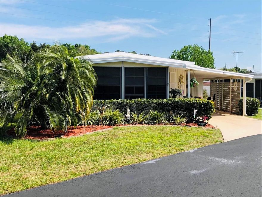 MOTIVATED SELLERS! Buy and own your HOME AND LOT in Les Chateau Villa! There is no burden or worry of paying lot rent or increases. This highly sought after 55 and older community offers a friendly neighborhood with water access for fishing and boating. Even more, it is situated along the well-known DORA CANAL! This two bedroom two bath double wide is furnished, move in ready and even offers additional guest quarters with a fold out couch. It is beautifully decorated with all of the comforts of home. The roof was replaced in 2021 and the lanai is equipped with marine grade windows. Sellers are offering $1000 back for new flooring! 
A reasonably low HOA fee includes grounds, sewer, trash and water. Note: It is a NO pet community.