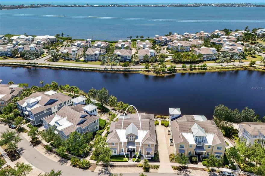 Tucked into the exclusive Mangrove Walk enclave of Harbour Isle, this 3BD/2BA condo offers a gracious take on coastal living—just before the bridge to Anna Maria Island, in a gated waterfront community that feels worlds away.
Inside, sunlight pours through expansive windows framing serene views of Sapphire Lake. Soaring ceilings, beamed detailing, and soft shiplap accents lend a sense of easy sophistication, while the open layout invites the kind of unhurried days the coast is known for. The kitchen is the natural heart of the home, anchored by an oversized island and finished with stainless appliances and generous cabinetry—designed for slow mornings and long evenings alike, flowing effortlessly into the dining and living spaces.
The primary suite is a quiet retreat, with water views, dual vanities, and ample closet space. A flexible den offers room to work, read, or welcome guests. Step out to the screened back porch for your private slice of the tropics—an ideal spot to linger over coffee or sunset cocktails. A private elevator and attached two-car garage round out the thoughtful details.
Life at Harbour Isle unfolds around the stunning Beach Club on Anna Maria Sound, where a sky bar and social lounge, resort-style pool and spa, fitness center, fire pit, private beach, and kayak launches set the tone. Walking and biking trails wind through the community, with additional neighborhood pools, grills, and on-site dining never far. Just beyond the gates, the Compass Hotel marina and Margaritaville-inspired Floridays restaurant complete the picture.
A rare opportunity to live the island life—gracefully, and just minutes from Anna Maria.