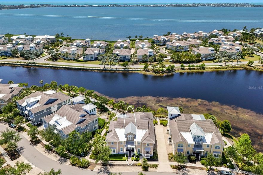 Tucked into the exclusive Mangrove Walk enclave of Harbour Isle, this 3BD/2BA condo offers a gracious take on coastal living—just before the bridge to Anna Maria Island, in a gated waterfront community that feels worlds away.
Inside, sunlight pours through expansive windows framing serene views of Sapphire Lake. Soaring ceilings, beamed detailing, and soft shiplap accents lend a sense of easy sophistication, while the open layout invites the kind of unhurried days the coast is known for. The kitchen is the natural heart of the home, anchored by an oversized island and finished with stainless appliances and generous cabinetry—designed for slow mornings and long evenings alike, flowing effortlessly into the dining and living spaces.
The primary suite is a quiet retreat, with water views, dual vanities, and ample closet space. A flexible den offers room to work, read, or welcome guests. Step out to the screened back porch for your private slice of the tropics—an ideal spot to linger over coffee or sunset cocktails. A private elevator and attached two-car garage round out the thoughtful details.
Life at Harbour Isle unfolds around the stunning Beach Club on Anna Maria Sound, where a sky bar and social lounge, resort-style pool and spa, fitness center, fire pit, private beach, and kayak launches set the tone. Walking and biking trails wind through the community, with additional neighborhood pools, grills, and on-site dining never far. Just beyond the gates, the Compass Hotel marina and Margaritaville-inspired Floridays restaurant complete the picture.
A rare opportunity to live the island life—gracefully, and just minutes from Anna Maria.