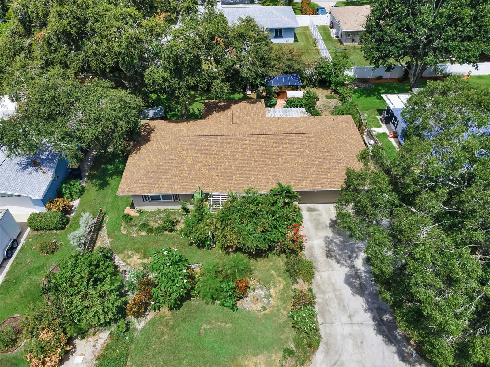 LOCATION! LOCATION! LOCATION! This beautifully maintained 2 Bed/ 3 Bath/ 2 Car Garage home in Clearwater is just 2 miles south of Downtown Dunedin, less than 2 miles from the Intercoastal Waterway, & The Pinellas Bike Trail is ready for it's next family to enjoy. BRAND NEW ROOF, no carpeting, & located in an X Flood Zone, so no requirement for Flood Insurance, a NON EVAC ZONE, NO HOA, and not affected by any storms. While you will absolutely love this charming home on the inside, you will likely want to spend most of your time in one the many AMAZING outdoor areas, as the photos will highlight. This is truly a Botanical Lovers DREAM, with so many exotic plants, fruit trees & bushes, flower bushes, vines, & trees (see list in attachments), as well as, a garden area ready for you to plant your favorite vegetables & herbs. The Shed in backyard will make the perfect "She Shed", studio, play house, or for outdoor storage. Keeping your outdoor area well watered is an ease with sprinkler system and new 4 pt. well w/ irrigation controls, installed in 2024. The 2 car garage has lots of storage space, a separated laundry room & a full bath with shower. Electric bills stay lower in this home, thanks to the newer windows, AC & Handler replaced in 2019, & 10 inches of insulation that has been blown into the ceiling above all of the living spaces. 2 Car Garage has space for Work Bench, storage & has separate Laundry Room, as well as, 3rd Full Bath w/ Shower. This location is just minutes to Indoor/Outdoor Entertainment, Dining, Shopping, & close proximity to both Clearwater Beach & Honeymoon Island. This AMAZING HOME is easy to show so make your appointment today!